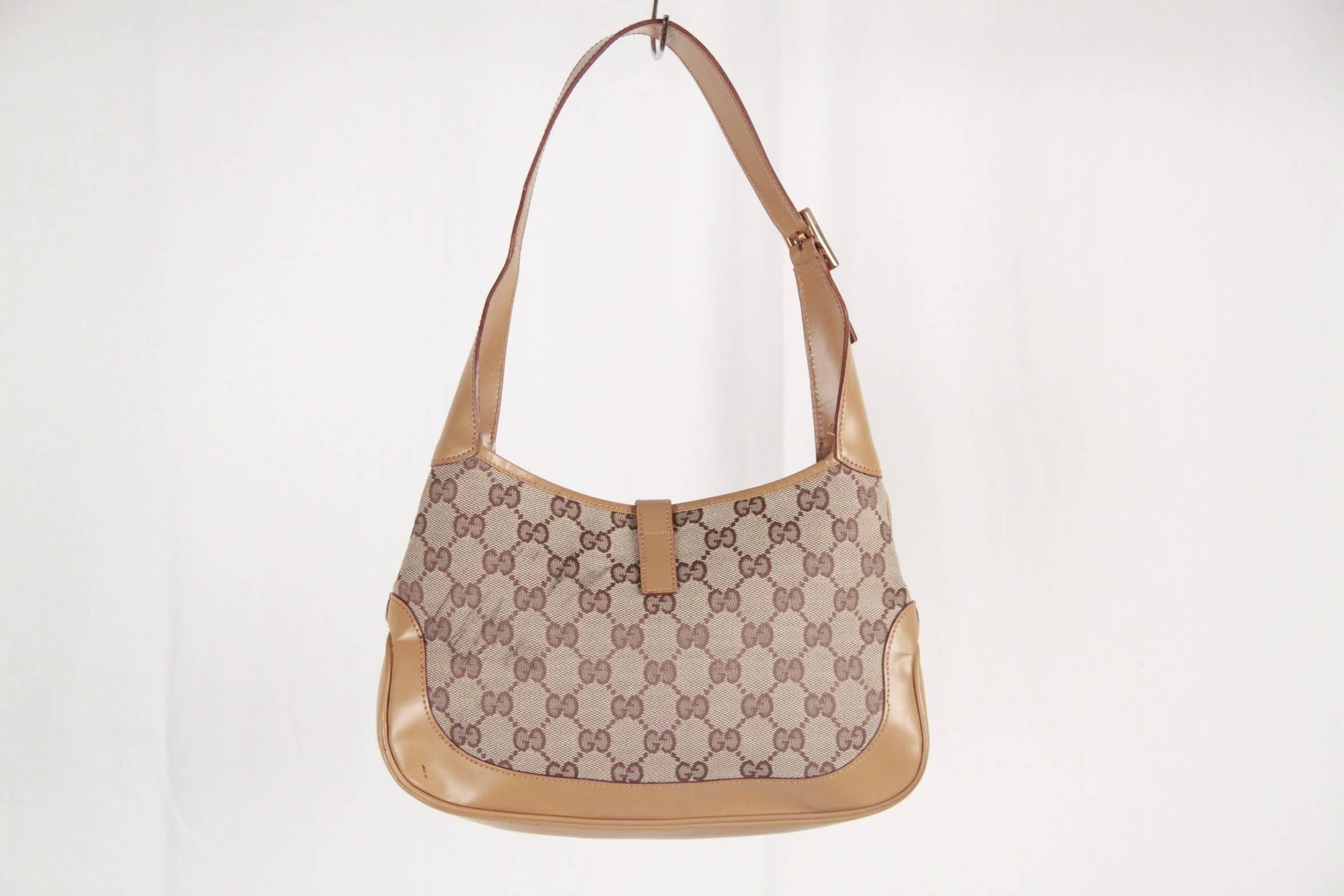 Classic and stylish is this Gucci Jackie O Hobo pefect for any occasion. Beige monogram canvas with tan leather trim and strap. The strap it is also embellished with silver toned metal hardware. The single strap is adorned with a silver buckle on