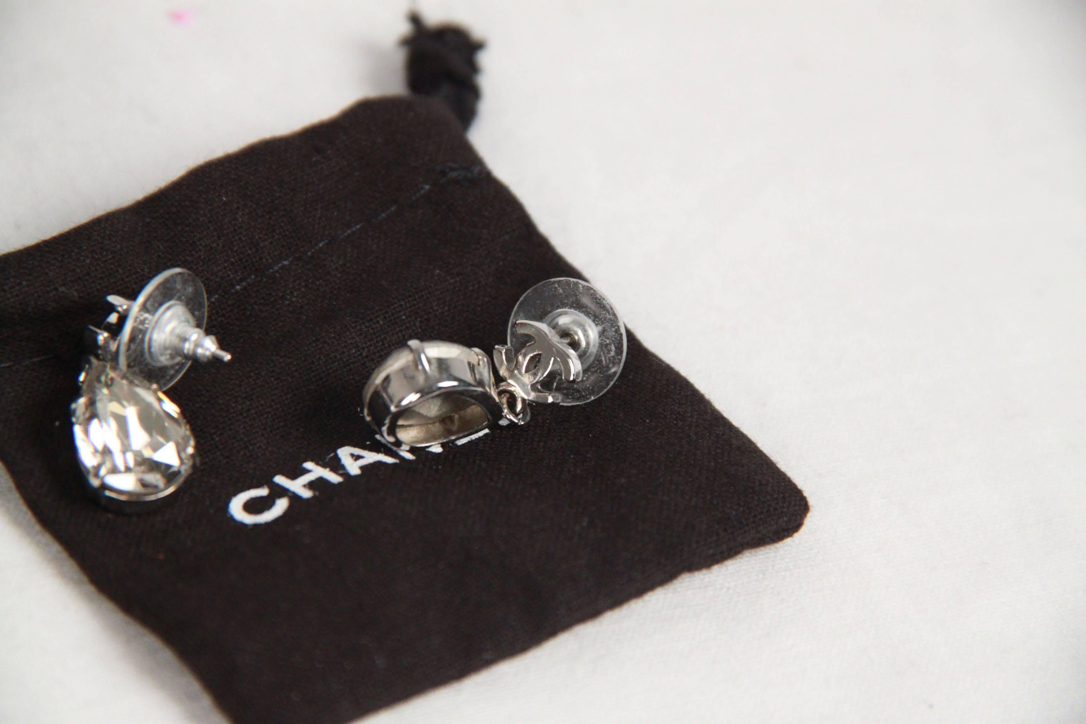 - Chanel Crystal & Silver CC Tear Drop Earrings
- Silver metal CC logos
- Teardrop-cut crystals
- For pierced ears
- Made in: Not given
- Stamp: Missing date stamp
- Total lenght: 0.75 inches - 2 cm
- Come with their original CHANEL box and pouch