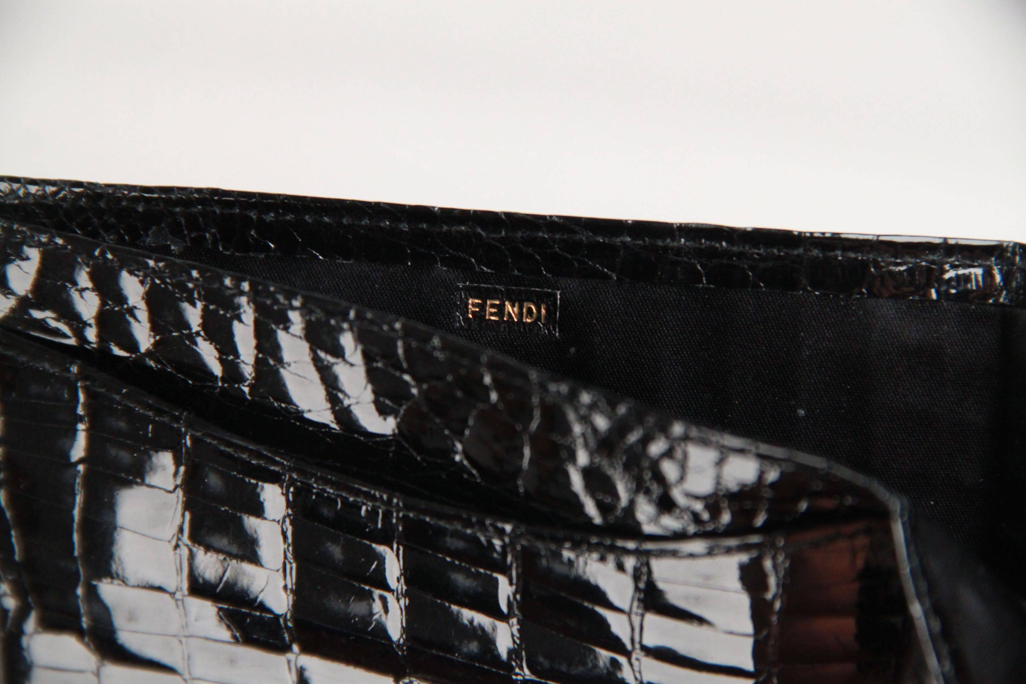- FENDI - Made in Italy
- Black crocodile leather
- Gold plaque on the front for incision
- Bifold design
- 1 bill compartment
- 3 open pocket
- Measurements (HxL): 3 1/4 x 4 1/4 inches - 8,2 x 10,7 cm

Logos / Tags: 'FENDI' embossed internally