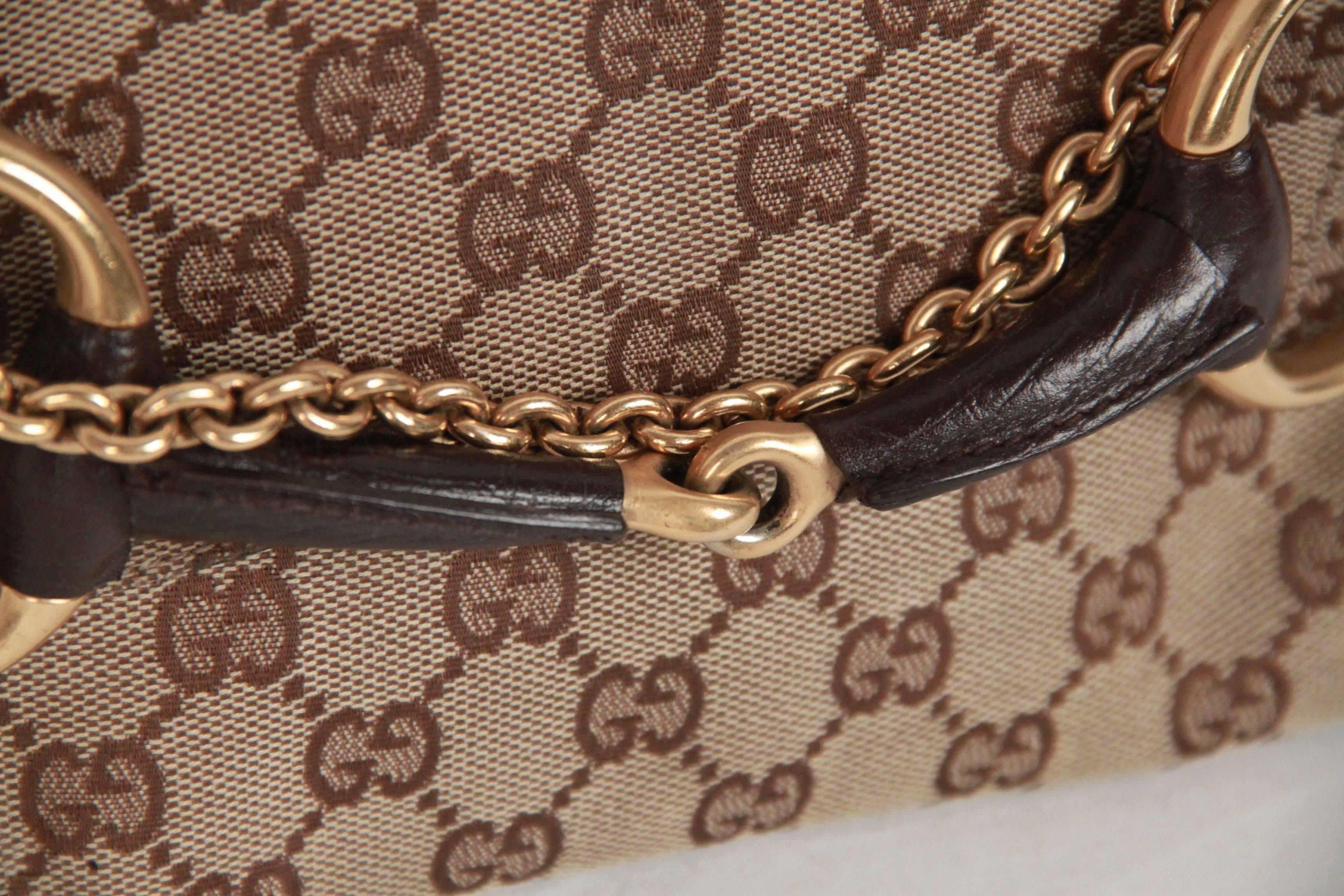 Rare Gucci clutch shoulder bag from the TOM FORD Era. It is crafted in GG monogram canvas with brown leather trim. The bag  features iconic horsebit detailing on the front and removable gold metal chain strap. Can be worn as a shoulder bag or as a