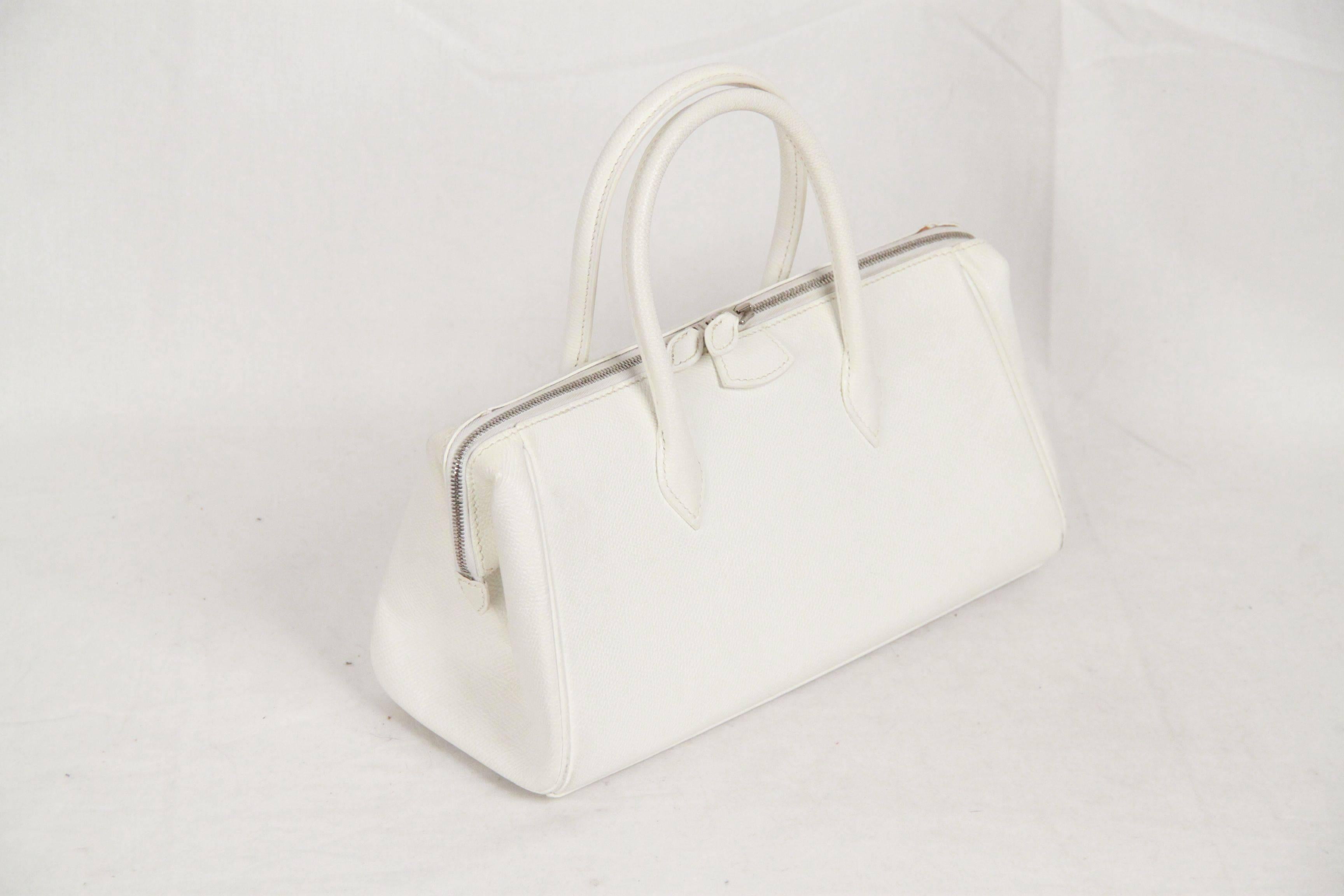 - Hermes 'Paris-Bombay' handbag 
- White leather 
- Two handles
- Double zipper closure
- Leather lining
- 2 pockets inside
- 4 bottom feet 
- Made in France
- Stamp J in a Square (2006)
- Measurements(HxLxD): 5.5 x 11 x 4.5 inches - 14 x 28 x 11.5