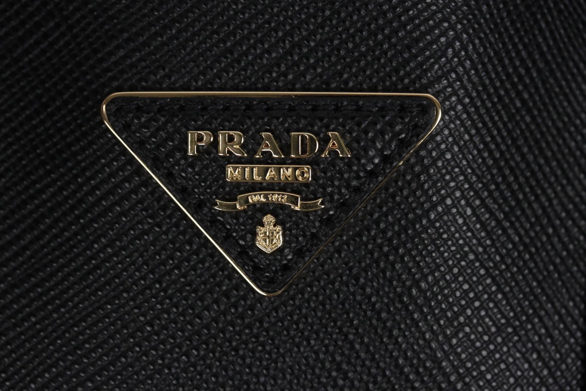 PRADA Double Bag Black Handbag mod. 1BG775, crafted from rich Saffiano calf leather and designed with a spacious two-compartment interior, this classic bag transitions seamlessly from workweek to weekend - a staple for any season. This Saffiano Cuir