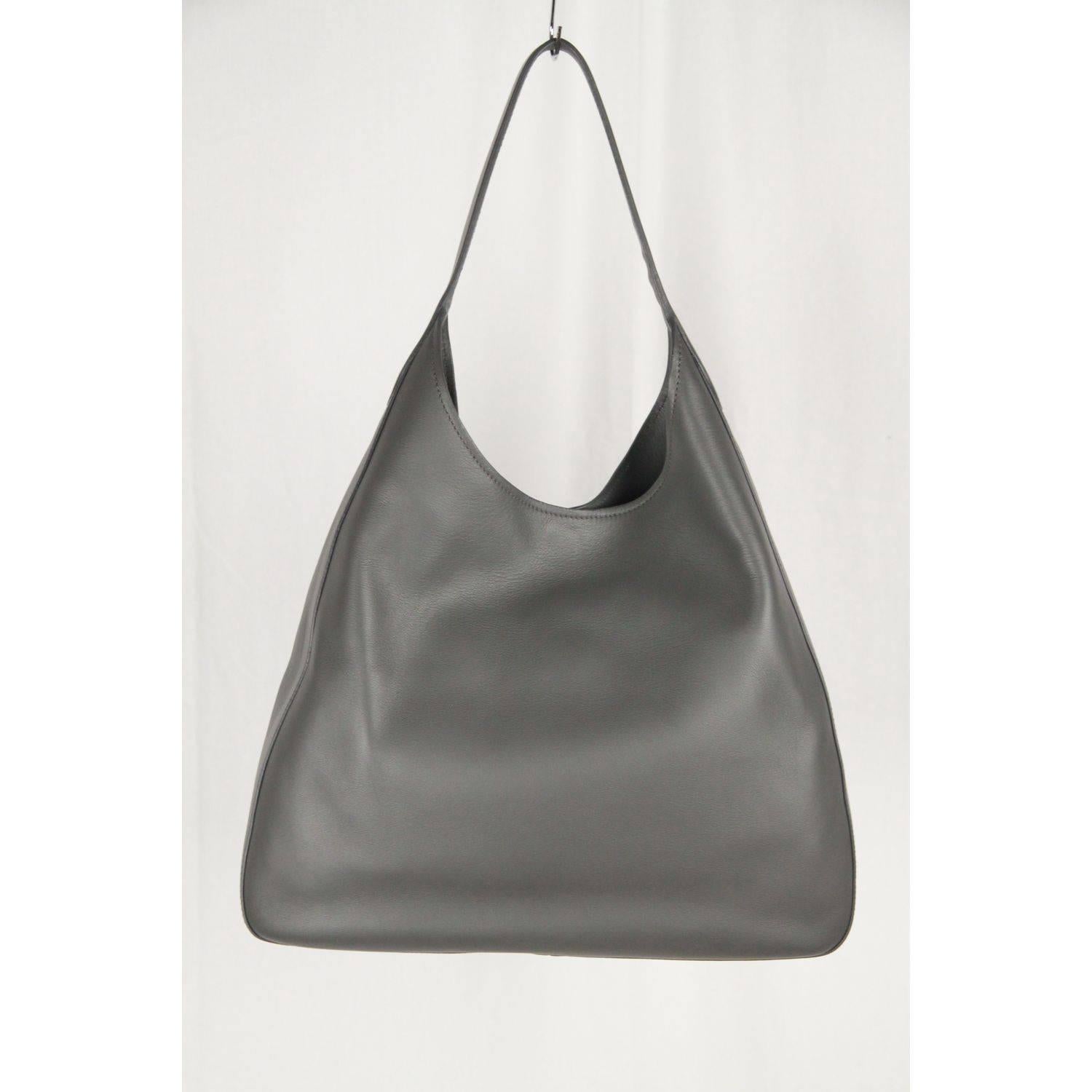 - Prada gray 'vitello corsica' leather hobo bag
- Mod. 1BC009
- Official PRADA color is 'MERCURIO'
- Flat shoulder strap (10 inches - 25,4 cm drop)
- Exterior slip pocket
- Dipped open top 
- Magnetic closure
- Leather lining
- 1 side zip pocket and