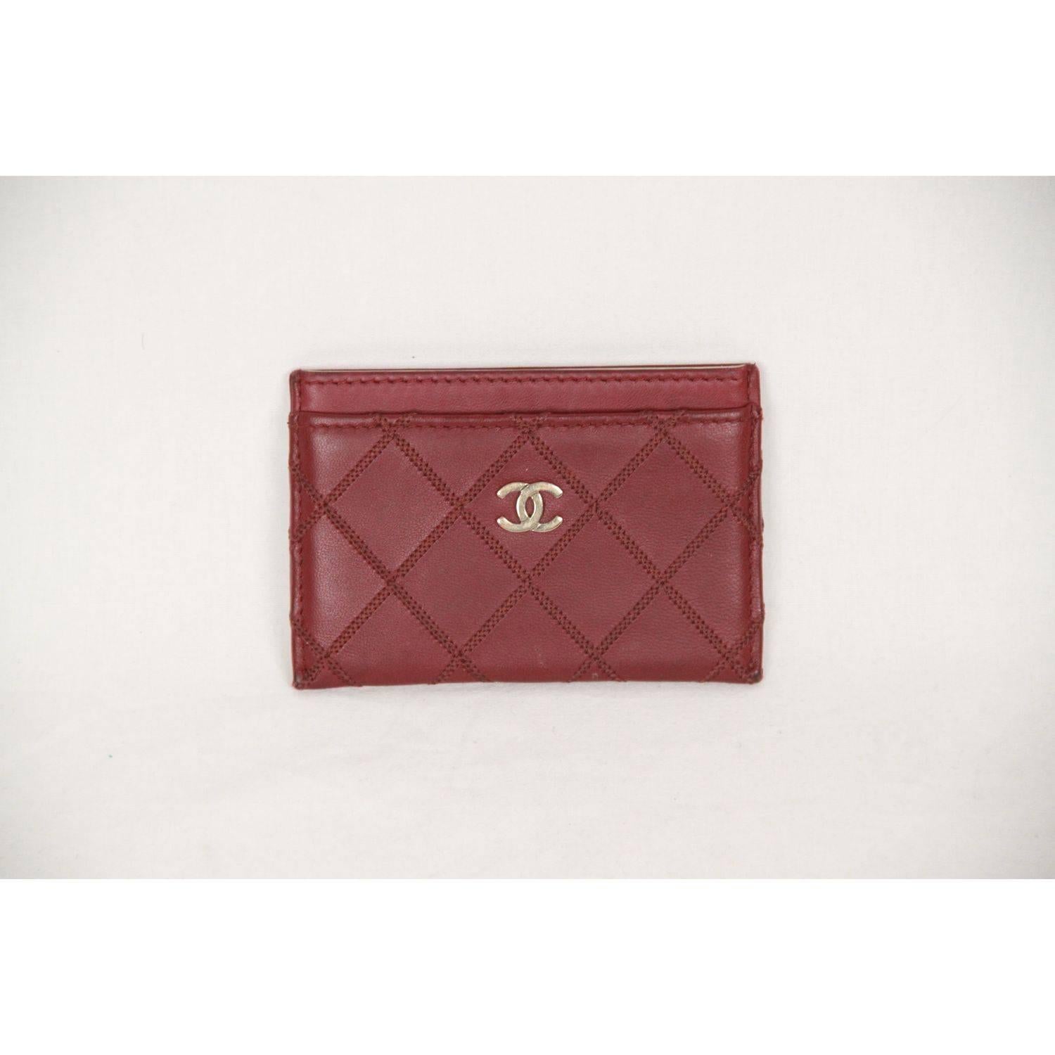 - CHANEL Quilted Credit card holder
- Burgundy leather 
- Iconic CHANEL quilt stitching
- Gold metal CC - CHANEL logo on the front
- Fabric interior
- 4 sections
- Measurements (HxLxD) 3 x 4.25  inches - 7,6 x 10,8 cm

Logos / Tags: 'CHANEL CC'