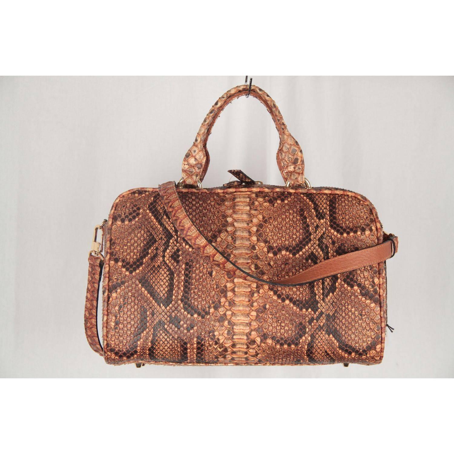 Stunning reptile satchel bag - Made in Italy - in tan snakeskin. It features a double zipper closure on top, gold tone hardware, double python handles and 4 bottom feet base. Lined with beige suede. Internally, it has 2 main compartment and 1 zip
