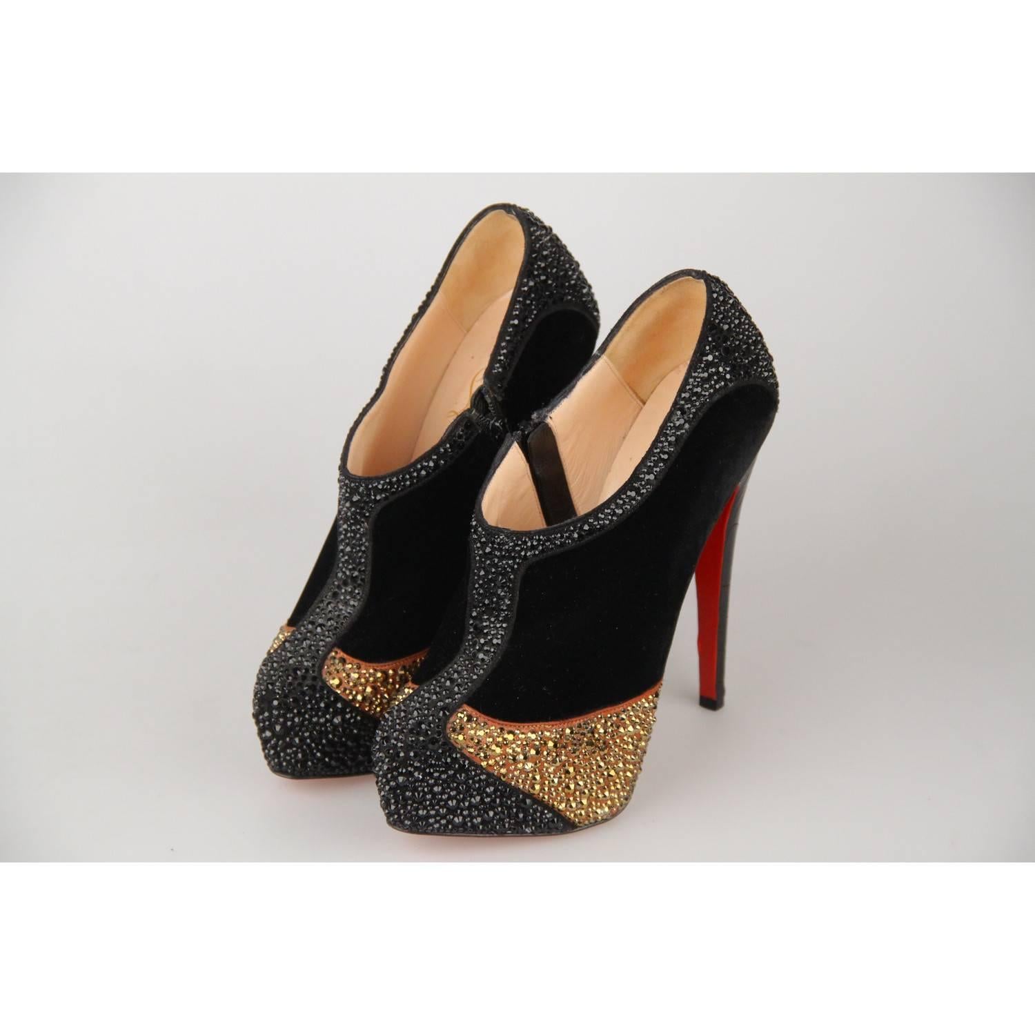- Christian Louboutin platform ankle boots
- Model: 'Laelia Strass 140' 
- TBlack velvet embellished with black and gold-tone Swarovski crystals
- Embossed Crocodile look leather covered heels
- Zip closures on the sides
- 5.5 inches - 14 cm covered