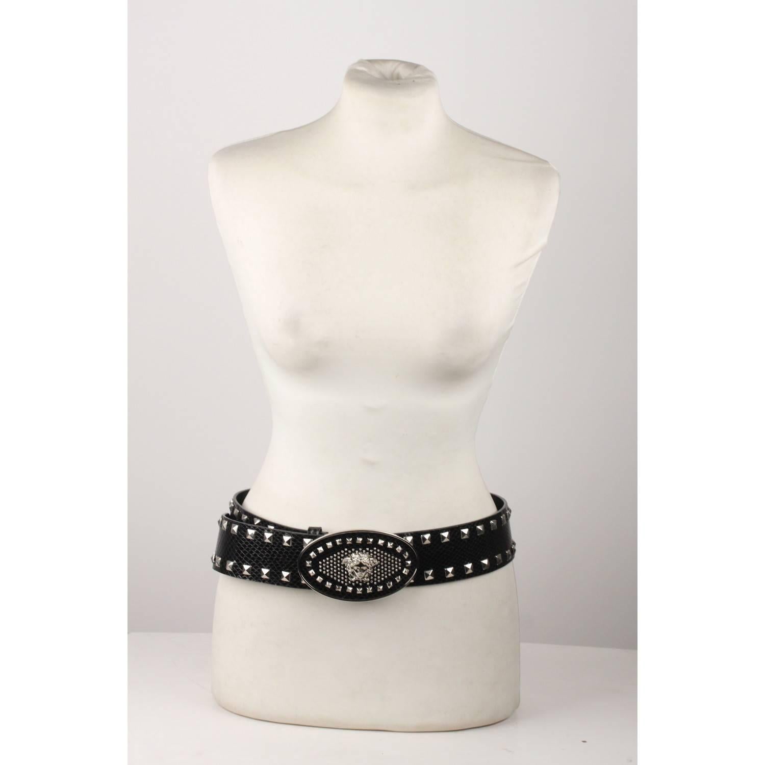 - Versace black wide belt
- Black leather with snakeskin look
- Silver metal pyramid studs
- Big oval buckle with Medusa
- Size. 85/34 
- made in Italy
- From buckle to first notch (Max circumference): 34 inches - 86,4 cm 
- From buckle to last