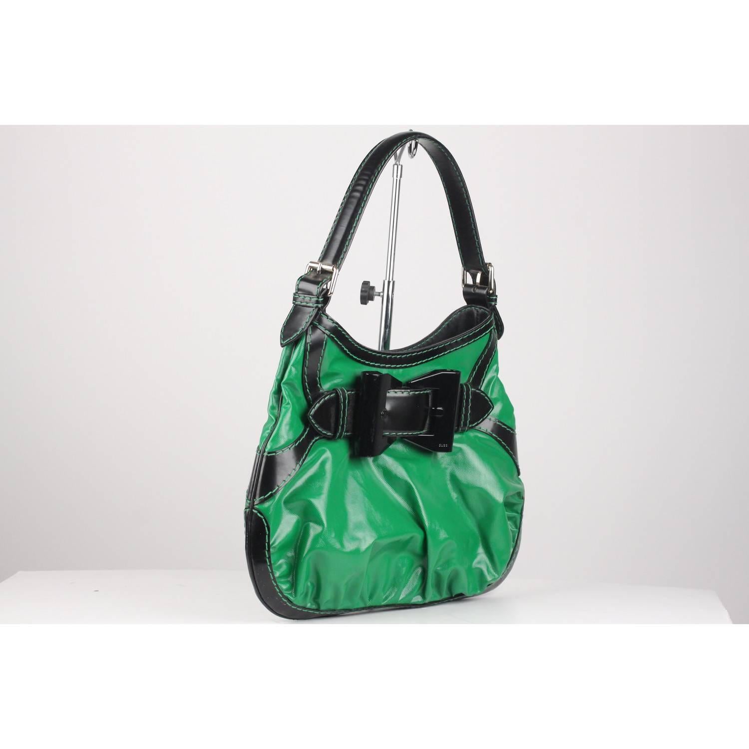 - Gucci 'Queen' Hobo Dialux Coated Canvas
- Crafted from green coated canvas with contrast black leather trim
- Oversized bow lucite buckle on the front
- Single loop leather handle
- Gold Tone hardware
- Magnetic button closure on top
- Gucci