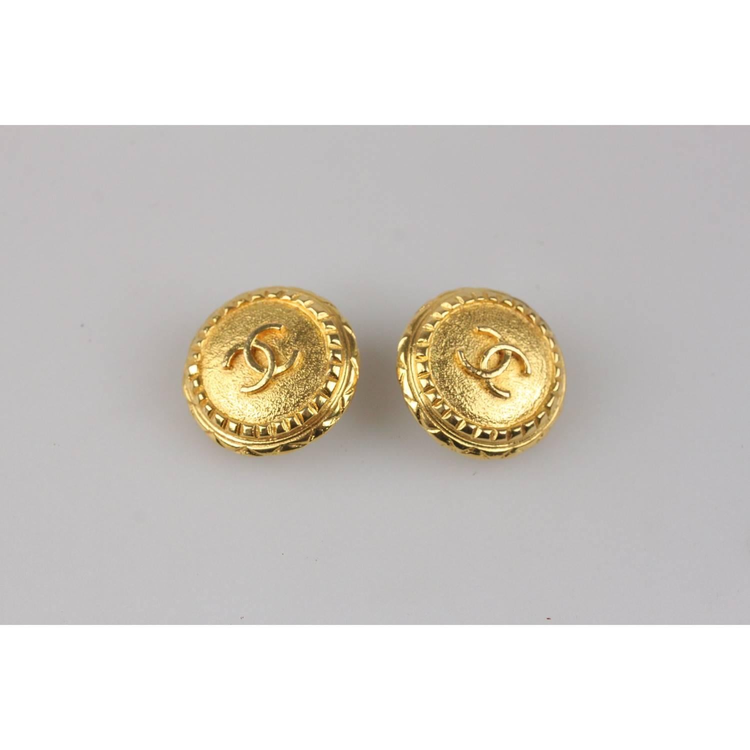 Vintage Round clip on logo earrings in gold metal by CHANEL.  'CHANEL - CC  - Made in France' round tag on the reverse of the earrings. 
