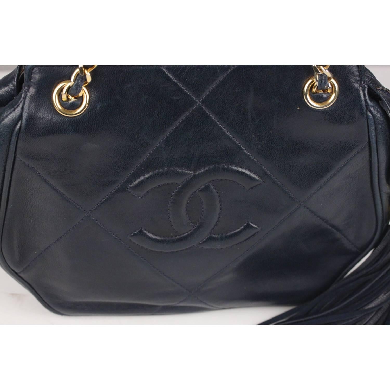 Lovely vintage Chanel shoulder bag with CC - CHANEL logo front stitching.. Crafted in navy blue quilted leather, it features upper zipper closure with big leather tassel zipper pull. Classic interwoven leather chain shoulder strap. the bag is lined