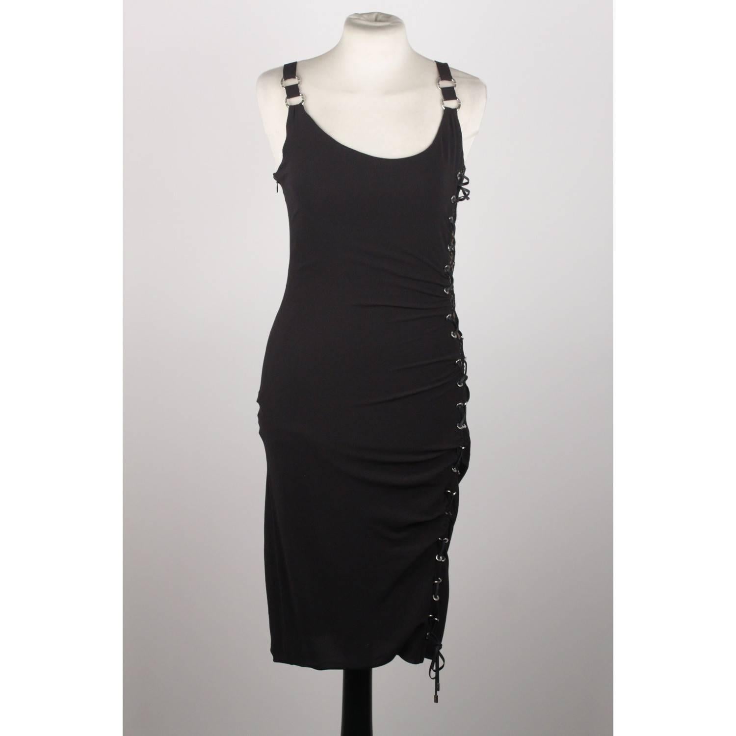Soft and lightweight fabric little black dress by VERSACE. It features scoop neck, close-cut bodycon fit, side zip closure. Beautiful lace panel on the side with lace up detailing. Composition: 90% Silk, 8% Elastane, 2%  Nylon. Size 40.
