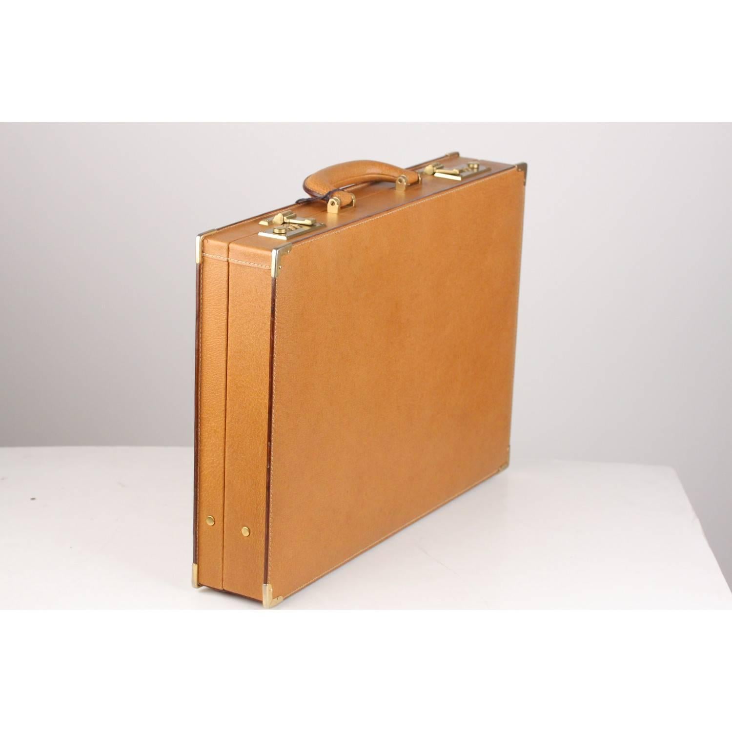 Gorgeous Gucci hard-side briefcase in tan leather. It is big and strong enough to carry your laptop and also provides plenty of space to organize and dived paper work, pens, phone, buisness cards, and more. Double combination lock closures