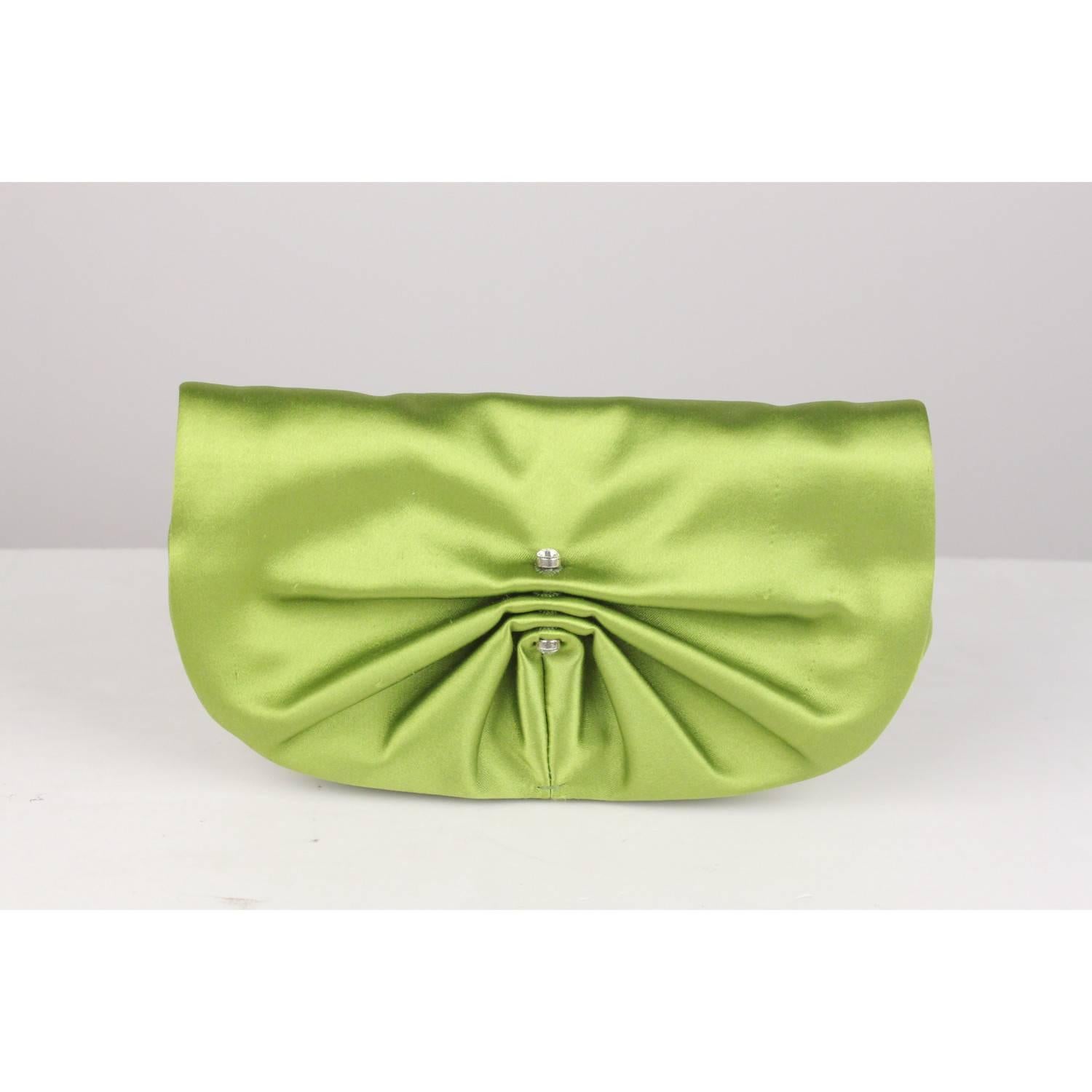 Sophisticated Yves Saint Laurent clutch bag in green satin. It features pleating on the flap, crystals detailing, flap with magnetic button closure and a small open pocket inside. 'YVES SAINT LAURENT Rive Gauche' embossed inside, serial number and