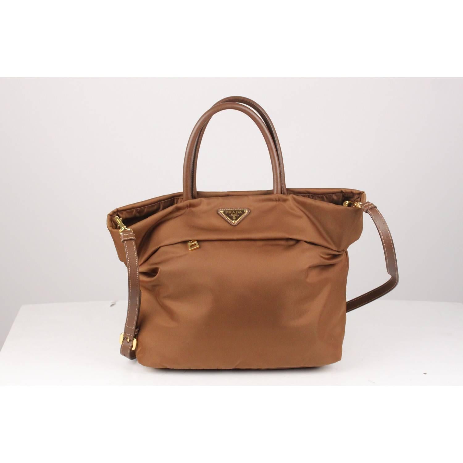 - PRADA Brown tote bag, mod. BN2531
- Prada official color is 'Corinto'
- Tessuto Nylon with Saffiano Leather Trim, handles and shoulder strap
- Gold metal hardware
- Prada triangle logo on the front
- 2 Concealed Exterior  Zip Pockets
- Detachable