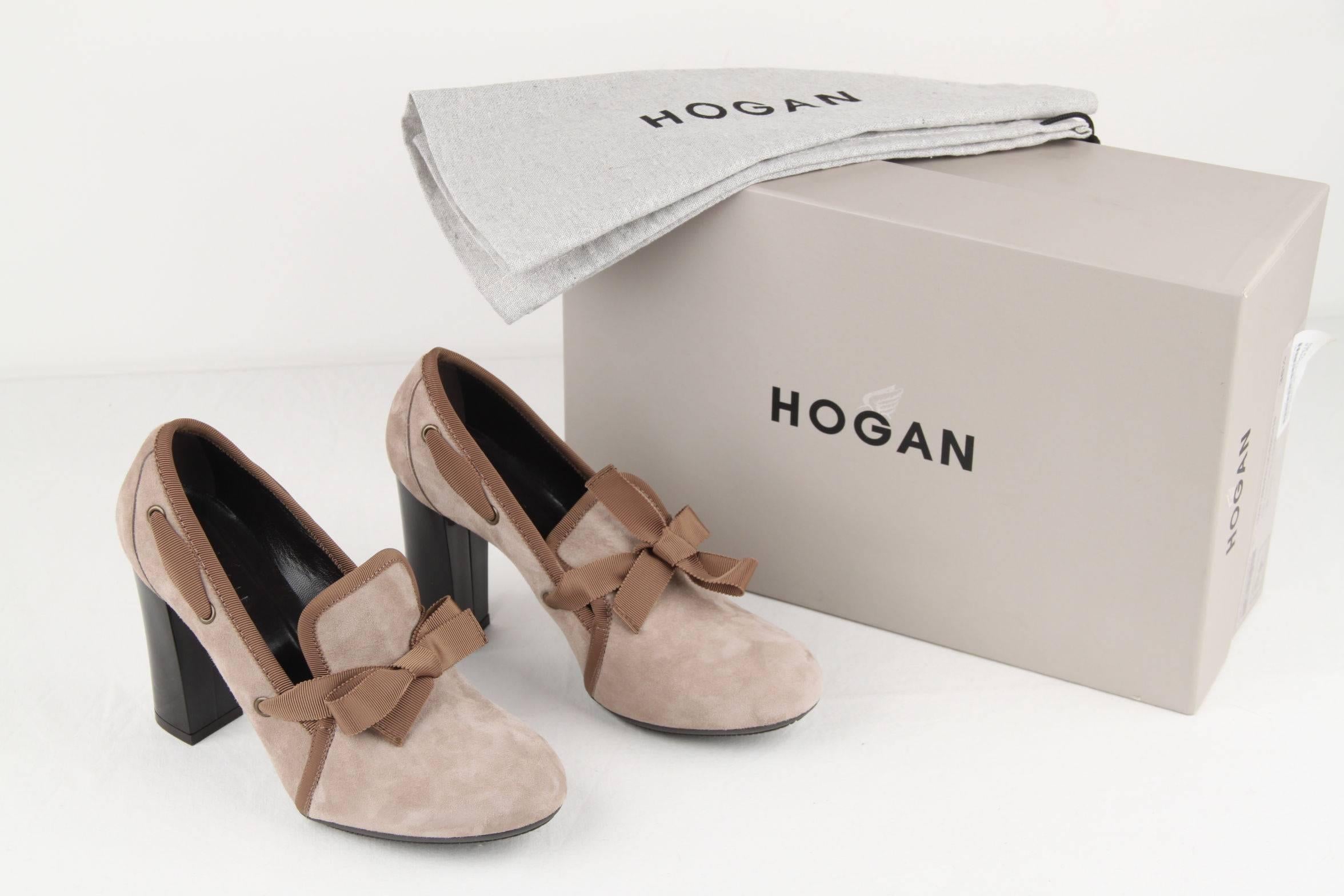 - HOGAN - Made in Italy
- Size 36 1/2 
- Round toeline 
- Gros-grain bow detailing and trim 
- Fabric / Material: Suede 
- Color / Effect: Taupe, Light Brown trim 
- Heel height: 4 inches - 10,2 cm 
- Width: 3 inches - 7,6 cm