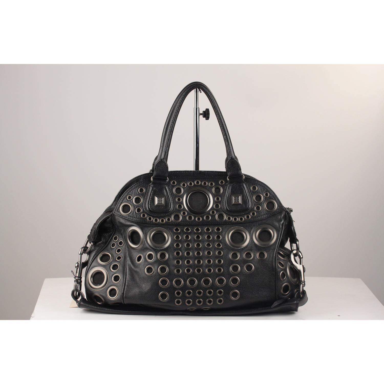 Stunning black leather Givenchy Bag with  super cool gunmetal grommet detailing on the front. Double top handles and removable shoulder strap. Upper zipper closure . Lined with black textile lining. Zip pocket and two slip pockets at interior.  