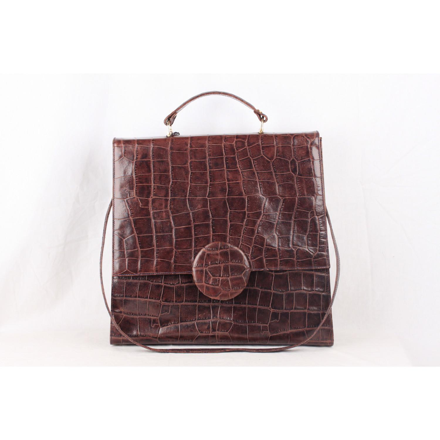 - 'ROY LA - Vera Pelle' tag inside 
- Brown Embossed leather with crocodile look
- Flap with clasp closure 
- 5 bottom feet
- Top carry handle
- Removable shoulder strap
- Suede lining
- 1 side zip pocket inside