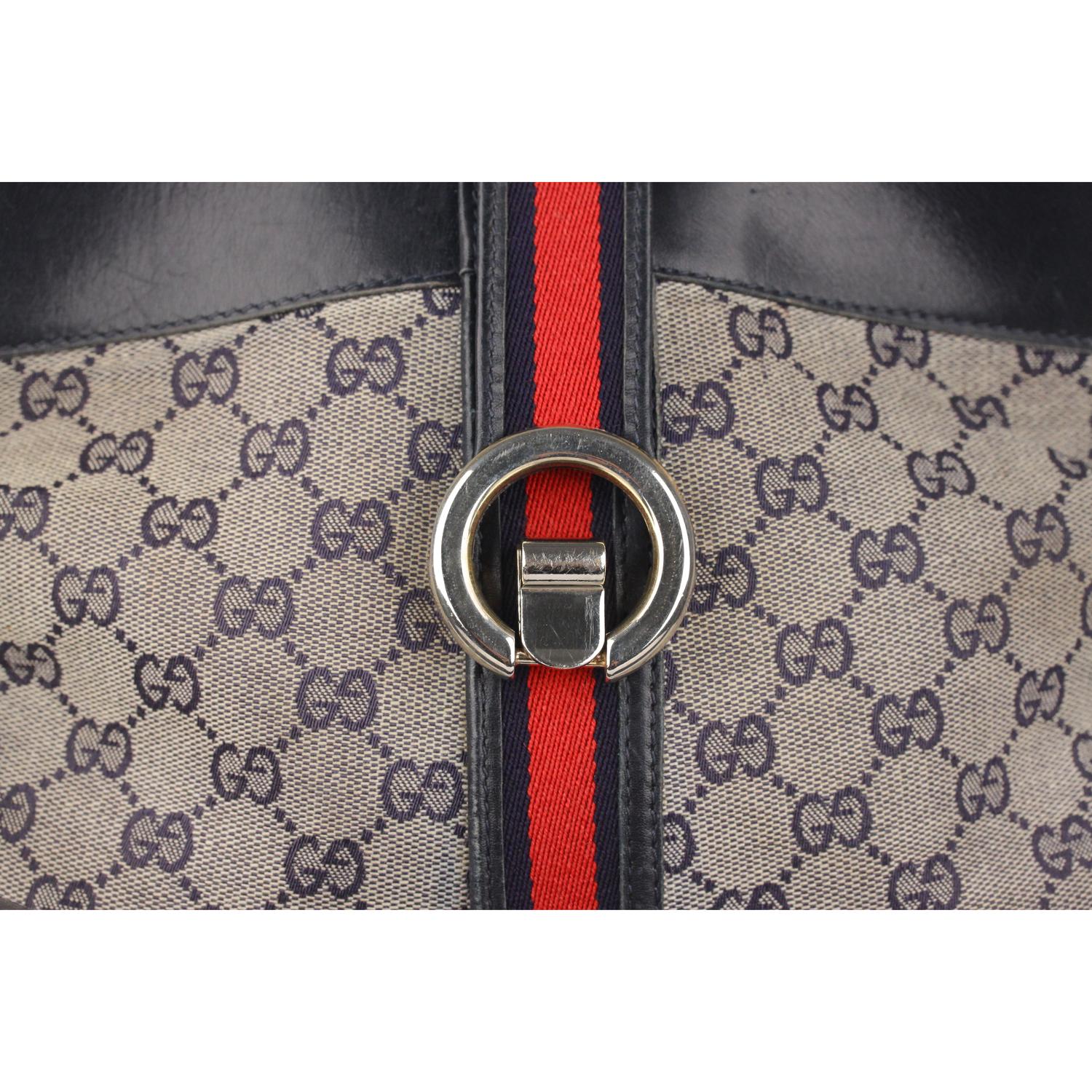 - Blue monogram canvas with genuine leather trim
- Blue/Red/Blue stripes detail
- Fold over strap with clasp closure
- Gold metal and silver metal hardware
- Blue diamond  lining 
- 1 zip pocket inside
- 'Made in Italy by GUCCI - Brevettato'