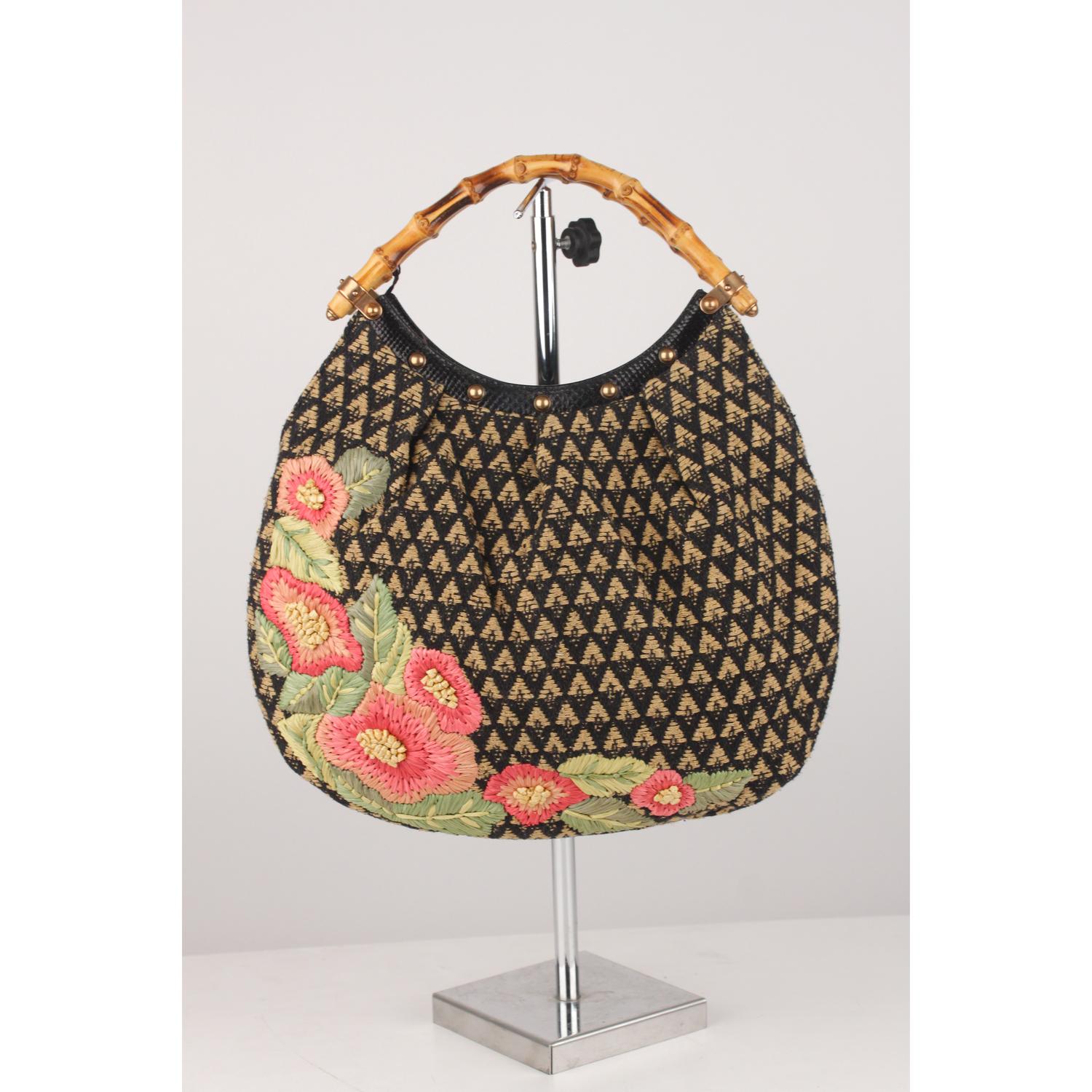 - Gucci limited edition hobo bag with bamboo handles
- Embroidered raffia flowers on canvas 
- Black leather trim on the opening with rose gold studs
- Open top
- Turquoise canvas lining 
- 1 side open pocket
- GUCCI - Made in Italy' tag inside