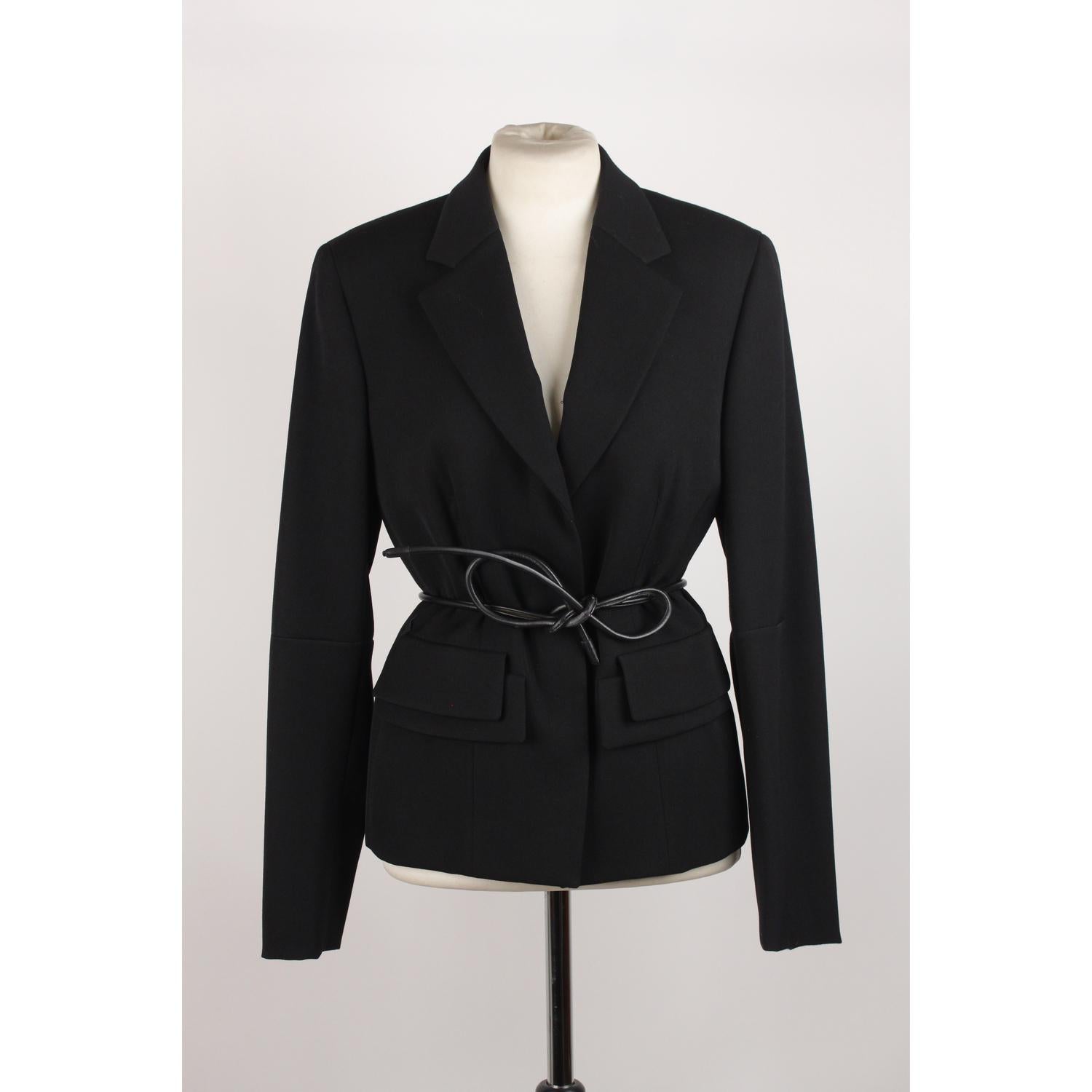 Single breasted wool blazer by GUCCI from the Tom Ford era. Black color.  Self-tie leather belt. Viscose lining. Button closure. Viscose lining and inner pockets. Size 42 IT (The size shown for this item is the size indicated by the designer on the