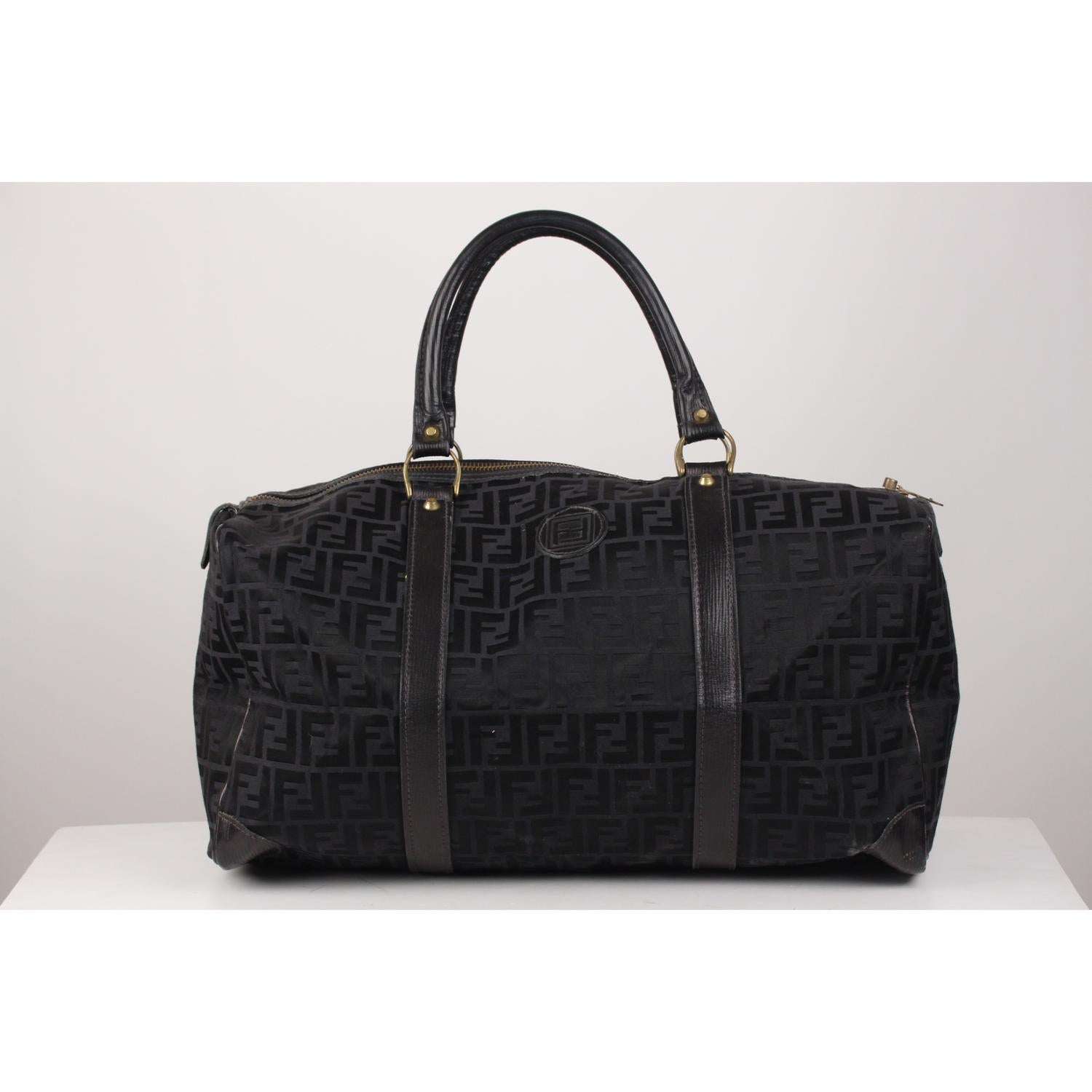 Vintage black monogram canvas with genuine leather trim by FENDI. FF - FENDI logo patch on the front. Double top carry handles. Upper zipper closure. Beige fabric lining. 'FENDI s.a.s. Roma - made in Italy' tag inside.