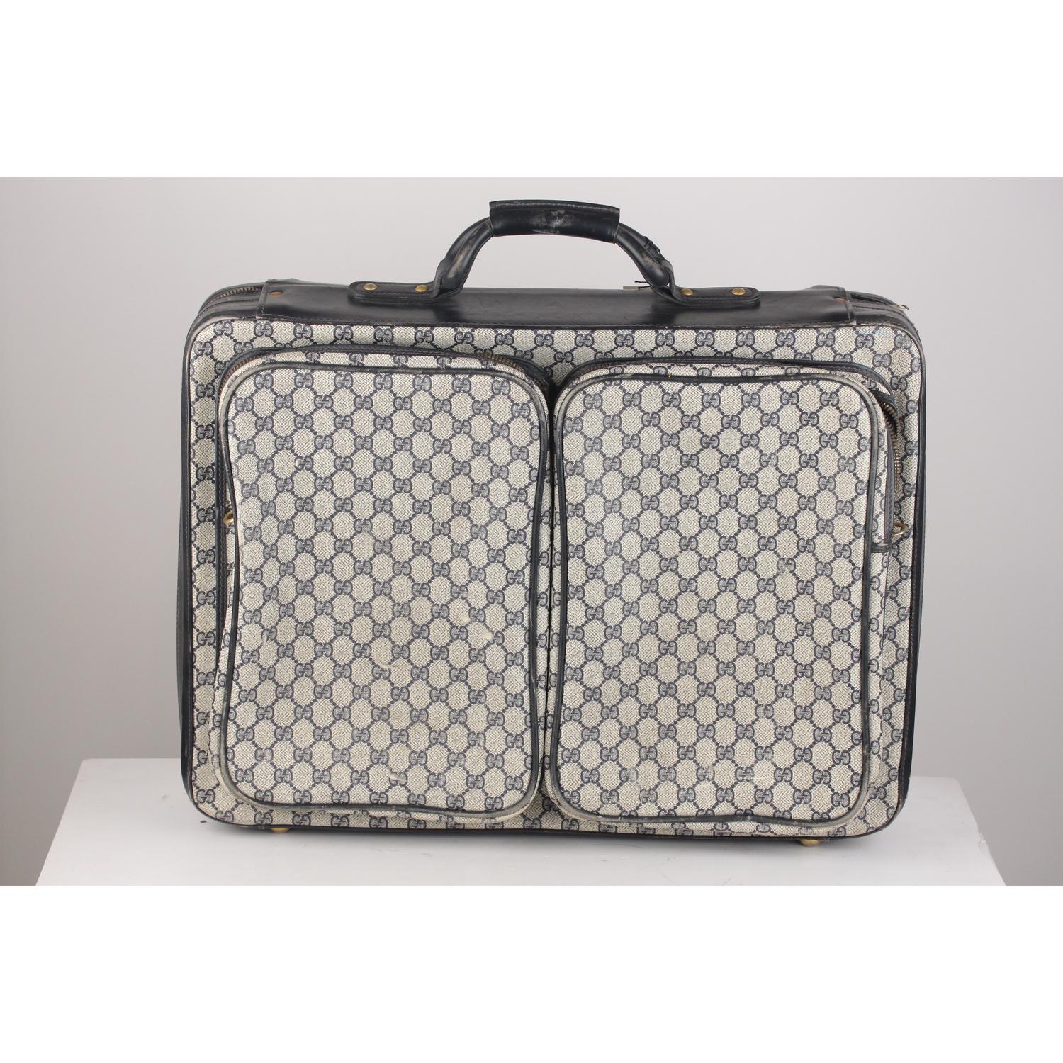 Vintage Gucci suitcase crafted of GG - GUCCI monogram canvas with blue leather trim. It features double wrap-around zip closure. Big front zip compartment and 2 rear zip pocket. Diamond fabric lining inside with 2 double leather straps to hold