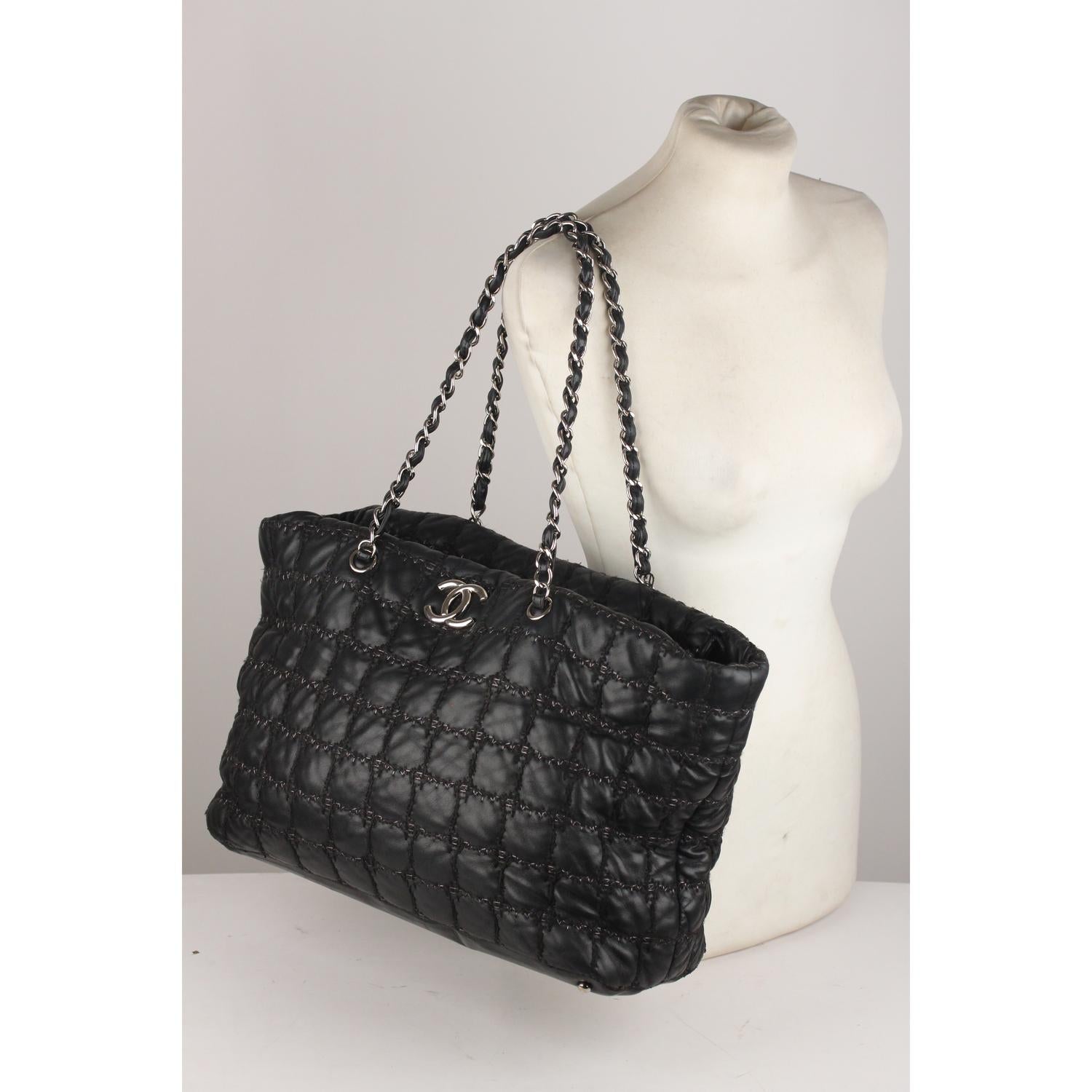 Chanel large 'Tweed Square Stitch' tote, crafted in black lambskin with black tweed stitching. Silver metal CC - CHANEL logo on the front. Upper zipper closure. Interwoven leather chain straps. inside it has gray satin lining, 1 side zip pocket and