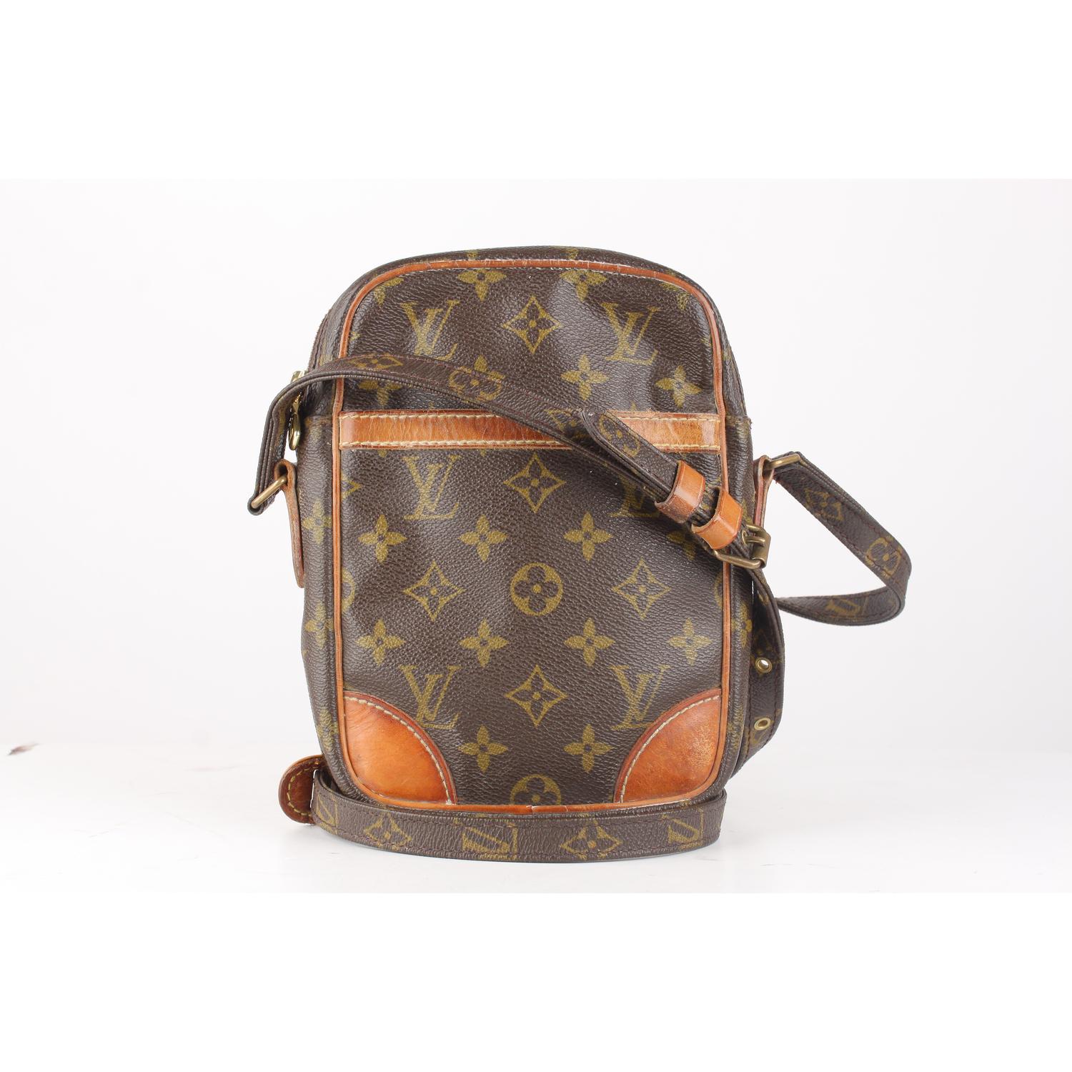 Stylish DANUBE messenger bag by LOUIS VUITTON, crafted in timeless monogram canvas. The bag features tan leather trim, a front open pocket and gold metal hardware.Adjustable leather shoulder strap with shoulder pad (53 inches - 134,7cm) The top