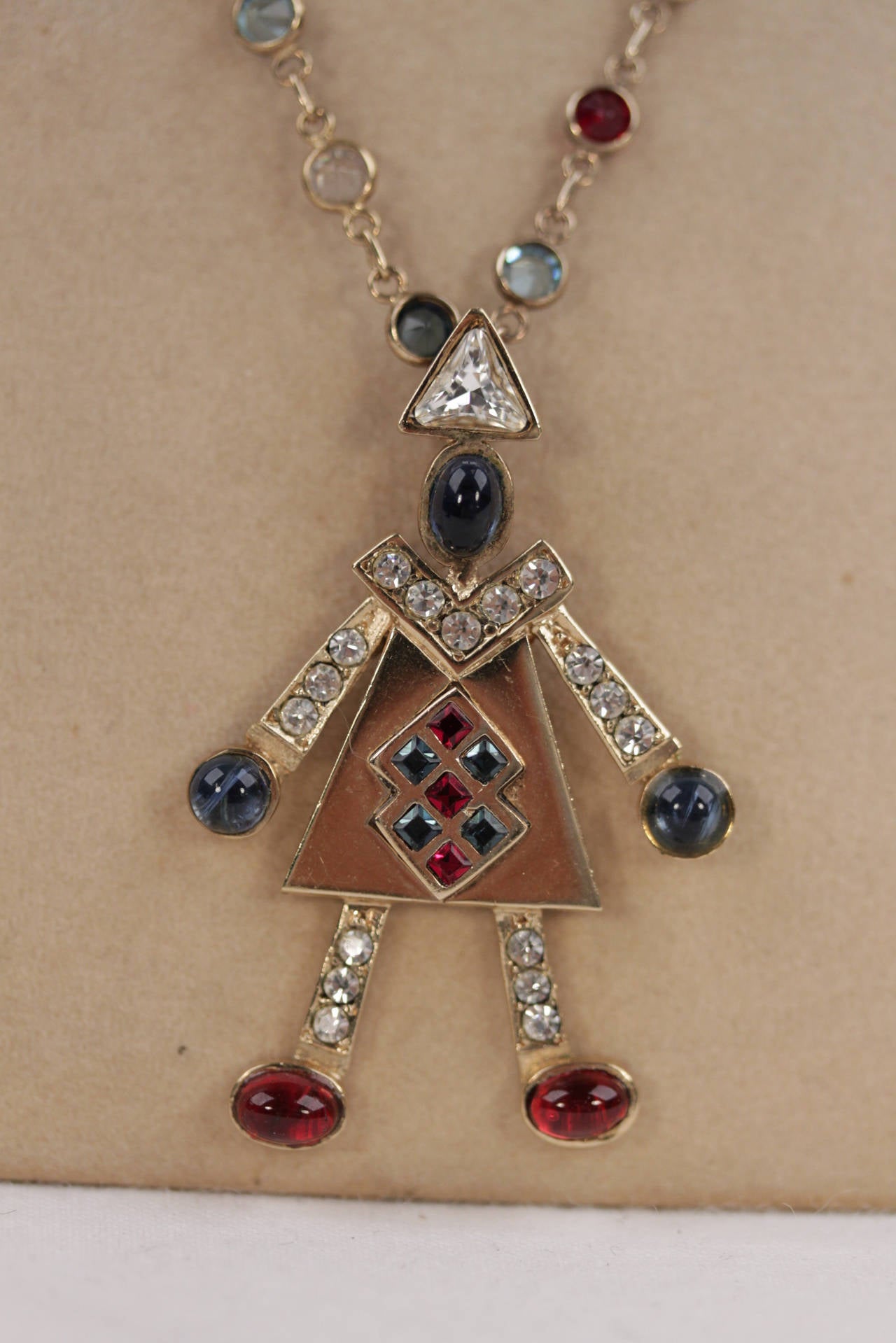 - Vintage Silver 800 chian with blue, red, light blue & white rhinestones

- Gold tone figure pendant with a white rhinestones and glass cabochon

- Clasp closure

- Engraved '800' hallmark on the chain - Total lenght: 16 inches - 40,5