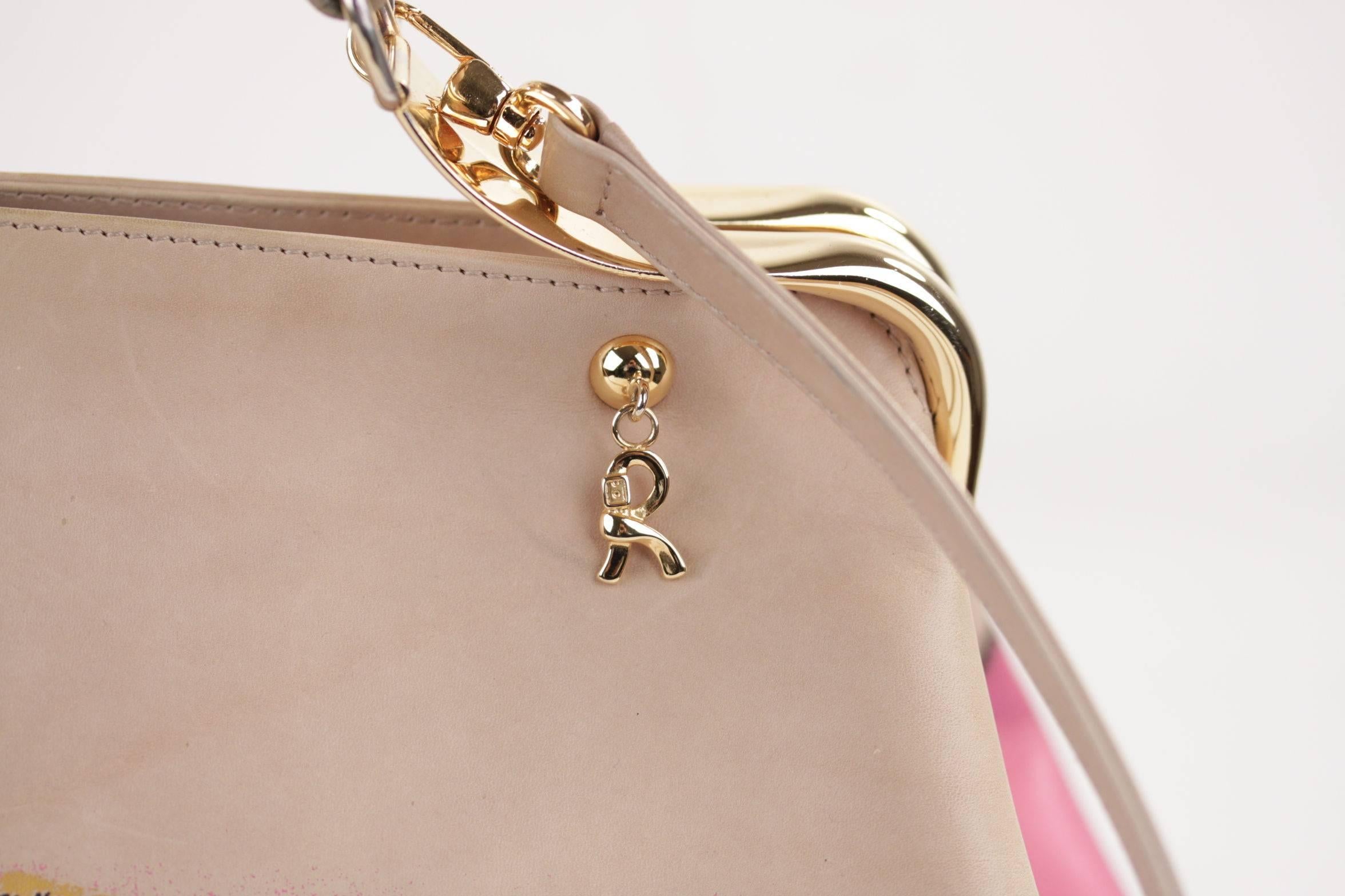  - ROBERTA DI CAMERINO beige leather doctor bag w/ Removable shoulder strap
- Pink belt detailing painted on leather
- Gold metal hardware
- Tiny gold metal‘R’ hanging from a stud on the front and on the back of the bag
- The interior is beige