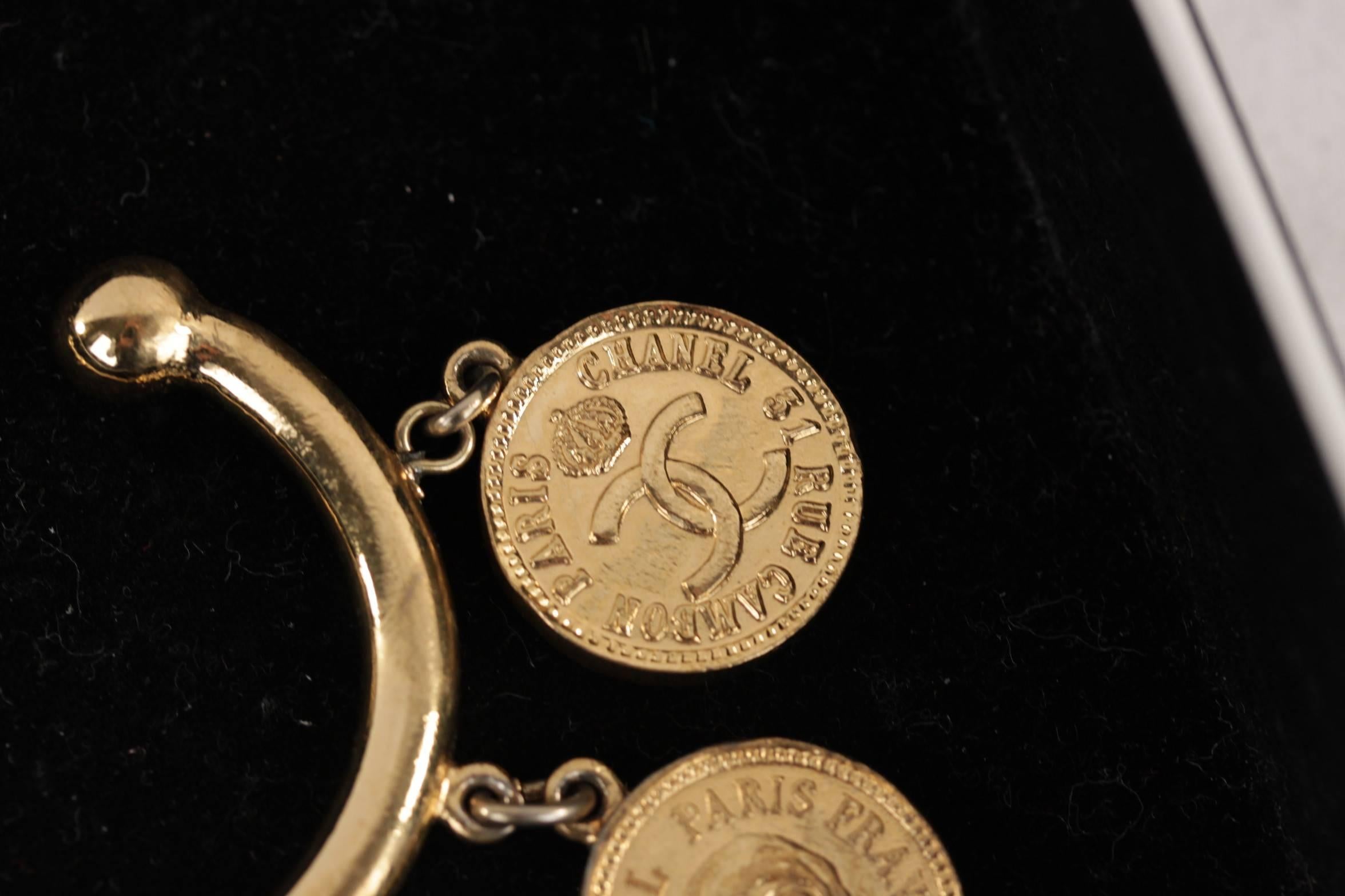 CHANEL Vintage Gold Metal BANGLE BRACELET w/ Signature COIN CHARMS w/ BOX In Excellent Condition In Rome, Rome