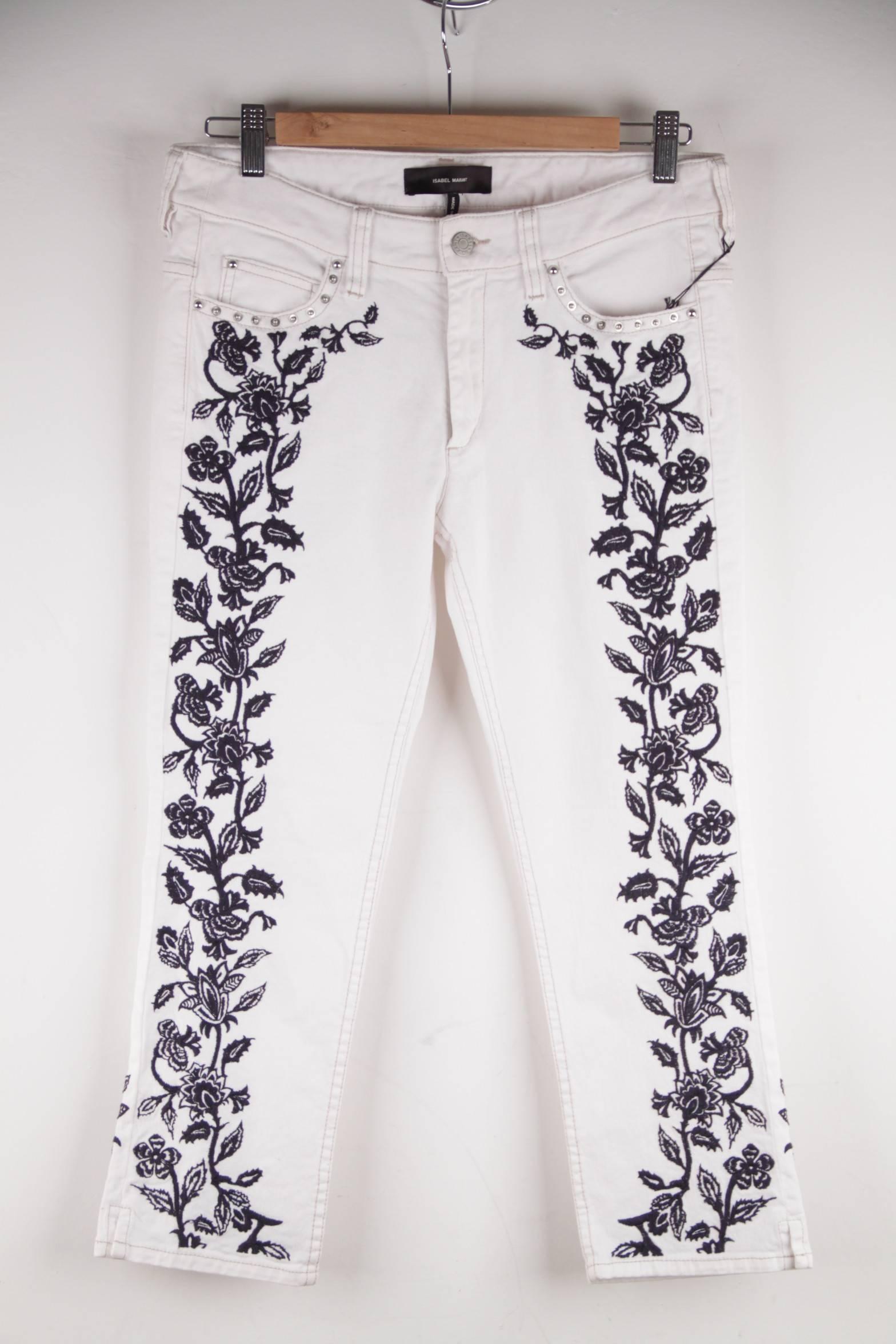  - White skinny fit denim
- Contrast embroidery
- Studs accents
- Ankle-grazing silhouette
- Belt loops
- Five pockets
- Button and zip fastening at front
- Slit at outer leg
- 97%% cotton, 3% elastane
- Size: 38 (The size shown for this