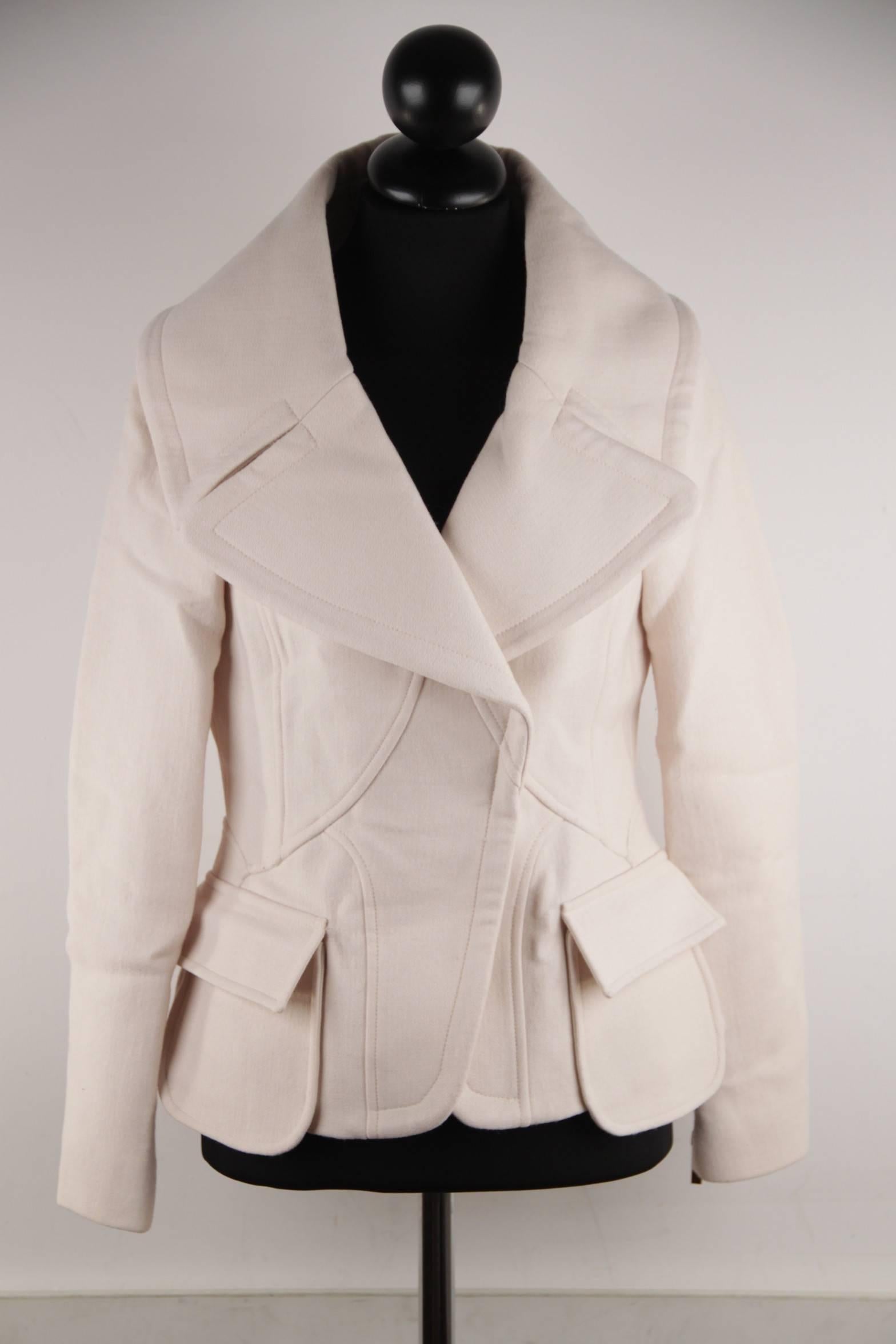  - Ivory wool jacket from the 2005 Fall Ready-to-wear collection by VERSACE
- Peacoat design
- Wide lapels
- Seam details throughout
- Dual flap pockets at waist
- Hidden snap closures at center front
- Composition: 99% Wool, 1% Elastane
-