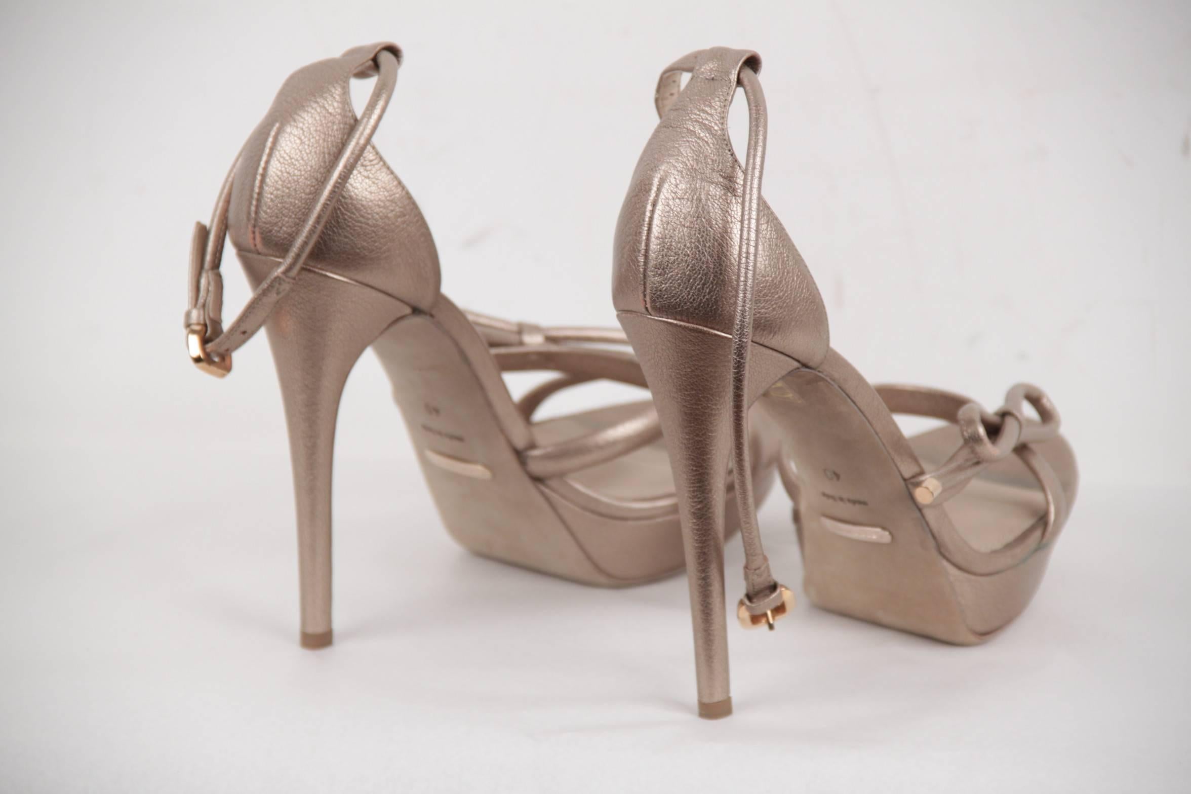 

- High heels BURBERRY 'Reigate' platform sandals crafted in gold-tone leather
- Bow detail at toe
- Ankle strap buckle closure
- Covered stiletto heels
- 4.75 inches - 12 cm heels
- 1 inch platform
- Leather upper, leather lining, leather