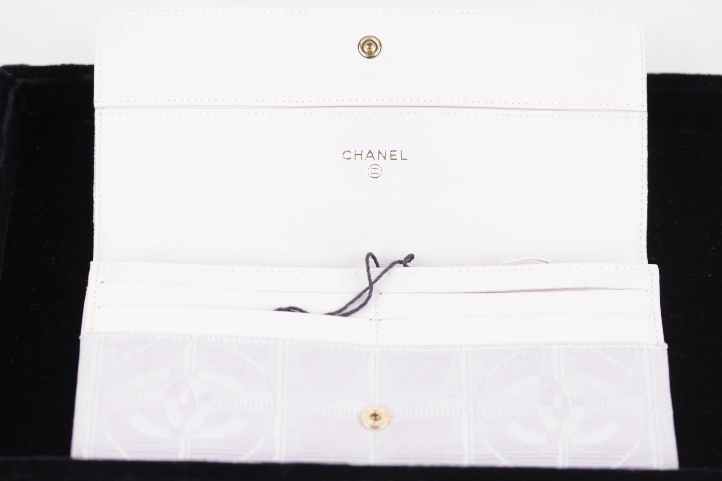  - Chanel Travel Line continental Wallet
- Lilac jacquard canvas with checkered pattern
- CC - CHANEL logo at front
- Flap with snap button closure
- Leather interior and satin lining
- one large open compartment inside
- 6 credit card