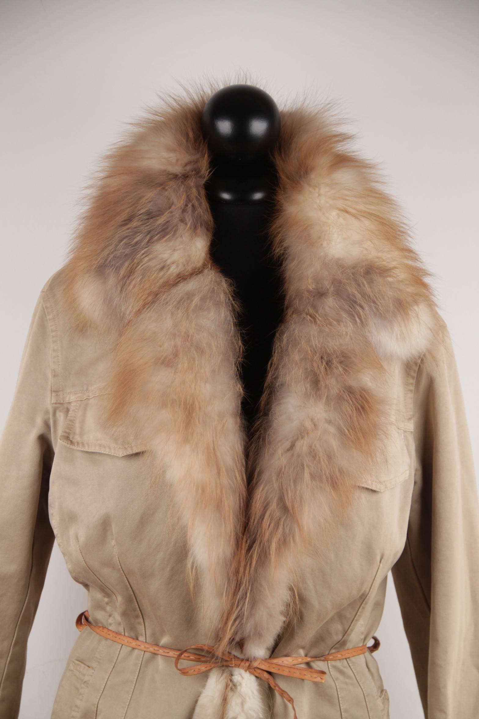 

- Beige color

- Nylon fabric

- Real fox fur trim

- Long sleeve styling

-Open front with leather self-tie belt

- Hooded neckline

- Zip detailing on the sides

- Adjustable Leather half belt on the back

- 2 flap pockets on