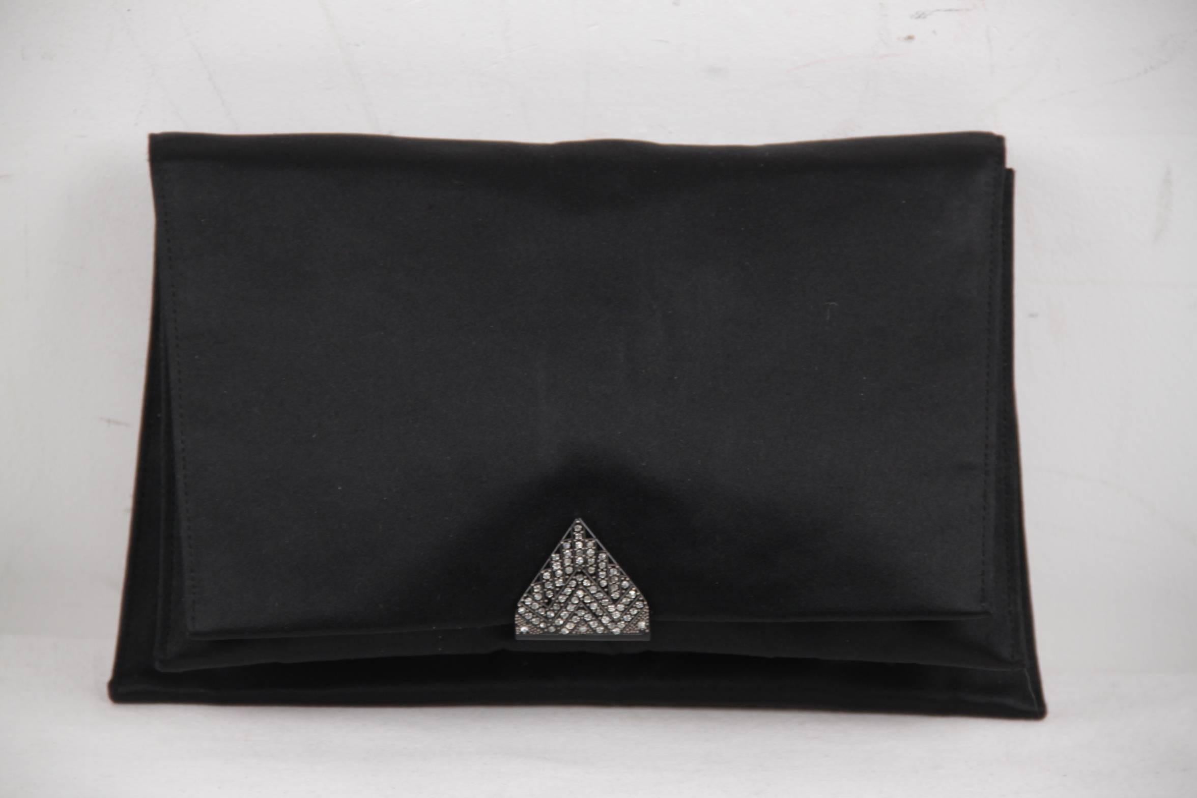 
- Vintage evening bag by CHISTIAN DIOR from the 1950s

- Flap with button closure on the front

- Black celluloid closure embellished by rhinestones

- 1 flat pocket on the back

- 2 main sections inside

- 3 open pockets inside

- It