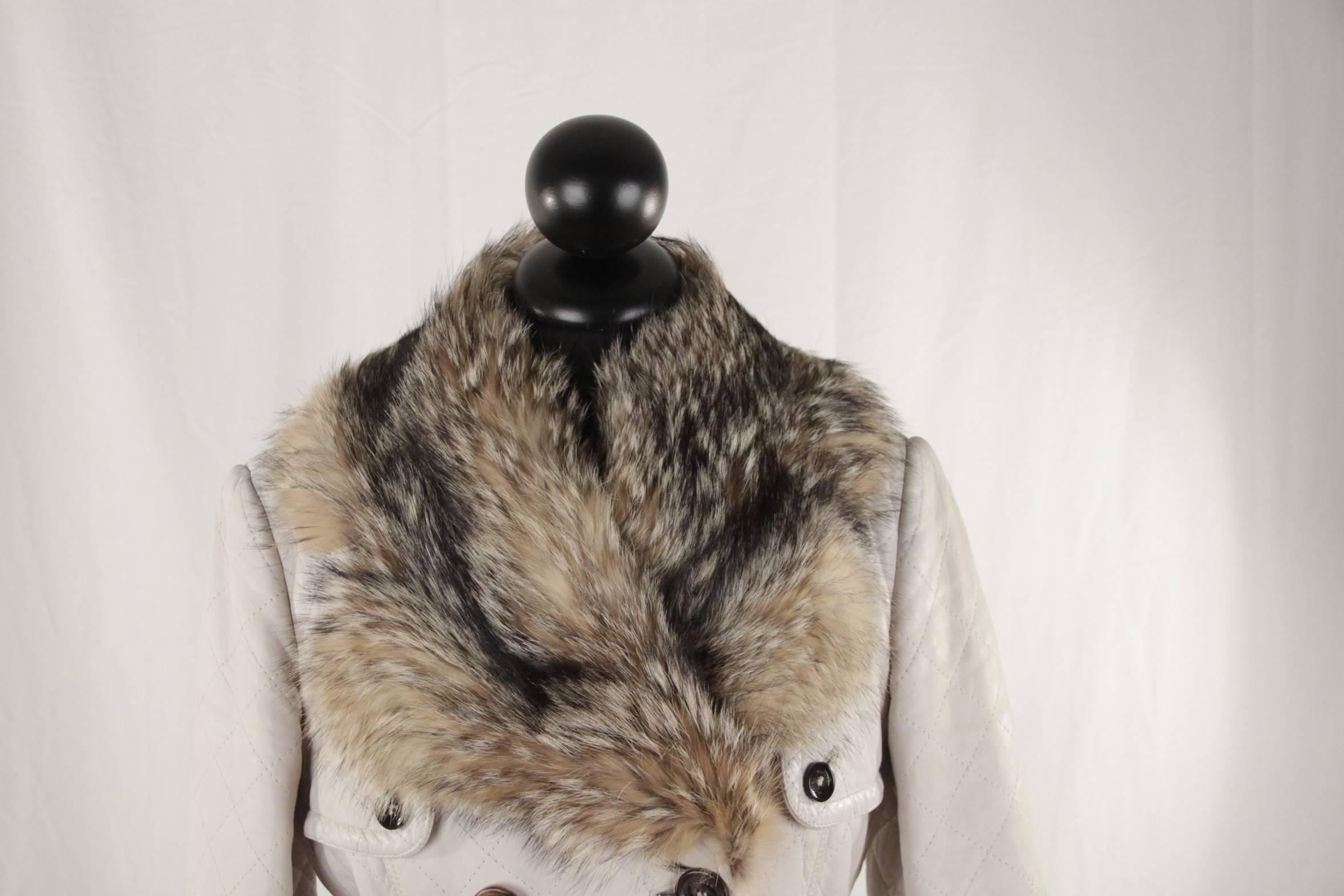  - Color: Off-White
- 100% lambskin leather
- Double-breasted design
- Button closure
- Belted waistline
- Gun flap
- Dual side flap pockets
- Fox fur trim on collar, hem & cuffs
- Fully lined with Polyester fabric
- Size: 42 IT (The size