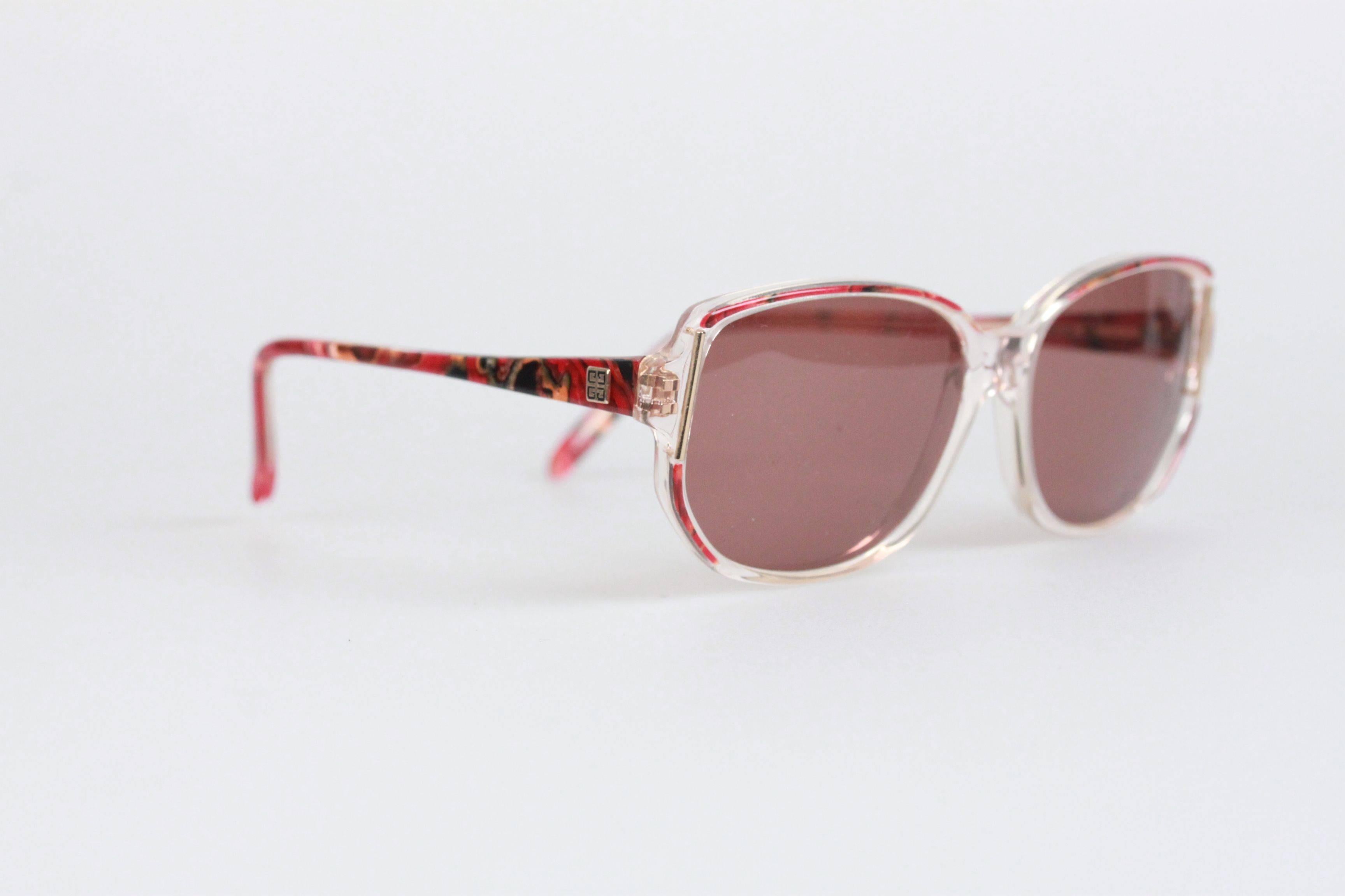 - Mod. G 8913
- Period/Era: 1980s
- Red Marbled / Clear plastic frame
- GIVENCHY logo on temples
- 100% UV protection gray lenses
- Made in France

Measurements:
- TEMPLE LENGTH: 135 mm
- TEMPLE TO TEMPLE - MAX WIDTH: 130 mm
- EYE / LENS WIDTH: 54