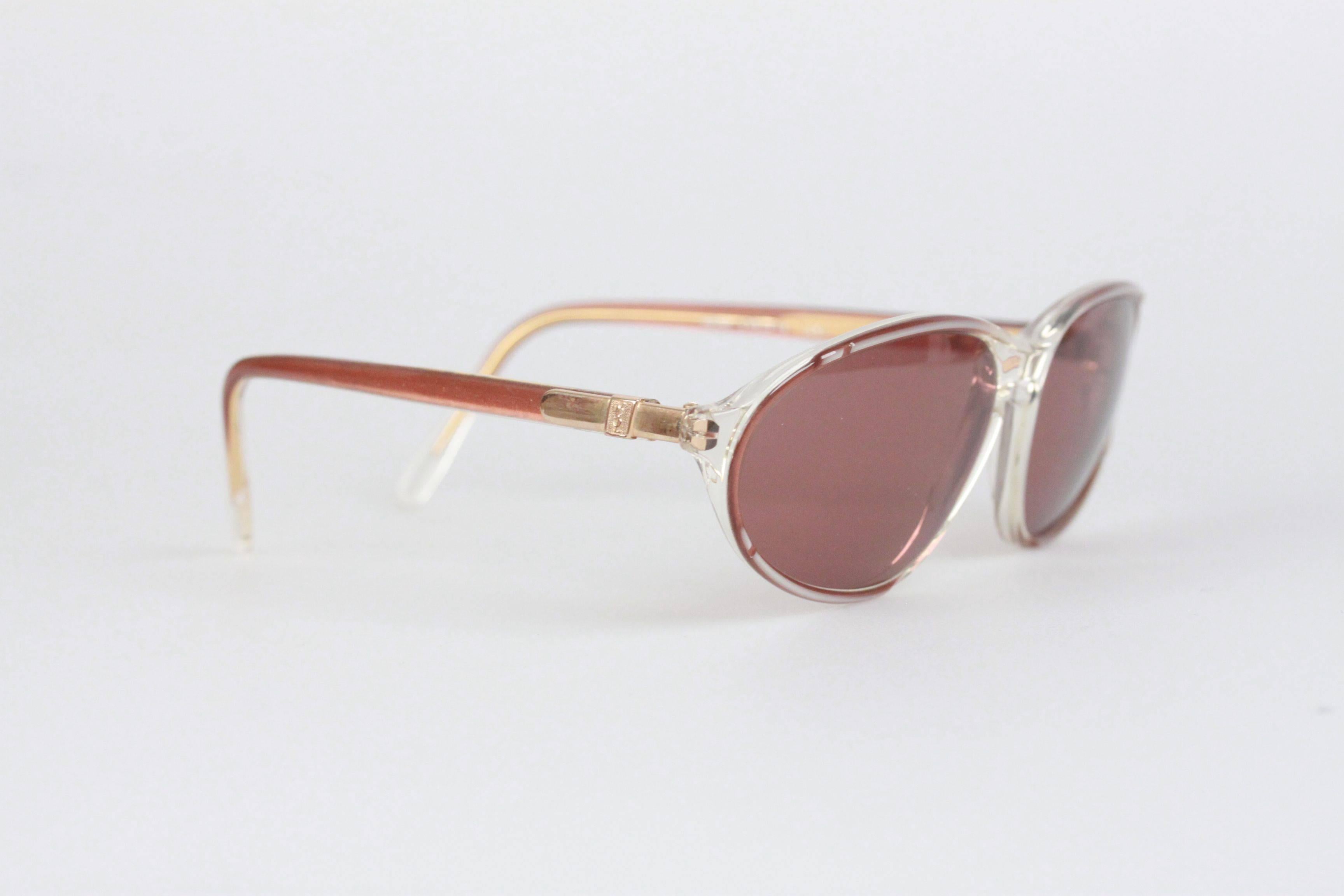 - Mod. HERE
- Period/Era: 1980s
- Brown-White/Clear plastic frame
- YSL logo on temples
- 100% UV protection gray lenses
- Made in France

Measurements:
- TEMPLE LENGTH: 130 mm
- TEMPLE TO TEMPLE - MAX WIDTH: 126 mm
- EYE / LENS WIDTH: 58 mm
- EYE /