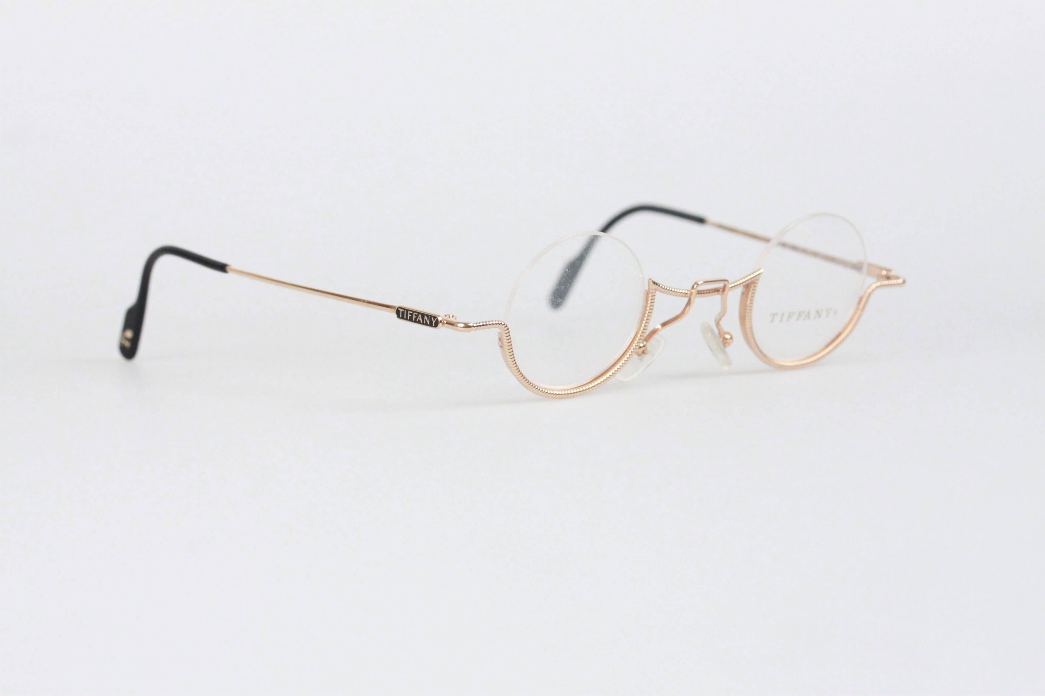 - High End Luxury 23kt Gold Plated Tiffany & co. eyeglasses
- mod. T64 - 36/11 - 14 - 23 K Gold
- Round and half-rim design
- Light Weight Full-Rim Frame, with DEMO/CLEAR lens
- TIFFANY logo on temples
- Comes with with original TIFFANY & Co.