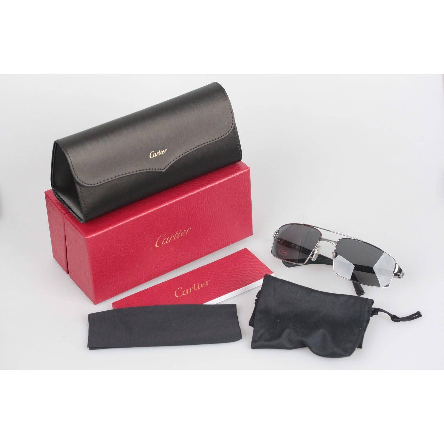 Platinum Brushed Sporty wrap Sunglasses by CARTIER
POLARIZED Gray lens
Soft Rubber on arms

Measurements:
- TEMPLE MAX. LENGTH: 120 mm
- TEMPLE TO TEMPLE - MAX WIDTH: 120 mm
- EYE / LENS MAX. WIDTH: 59 mm
- EYE / LENS MAX. HEIGHT: 38 mm
- BRIDGE