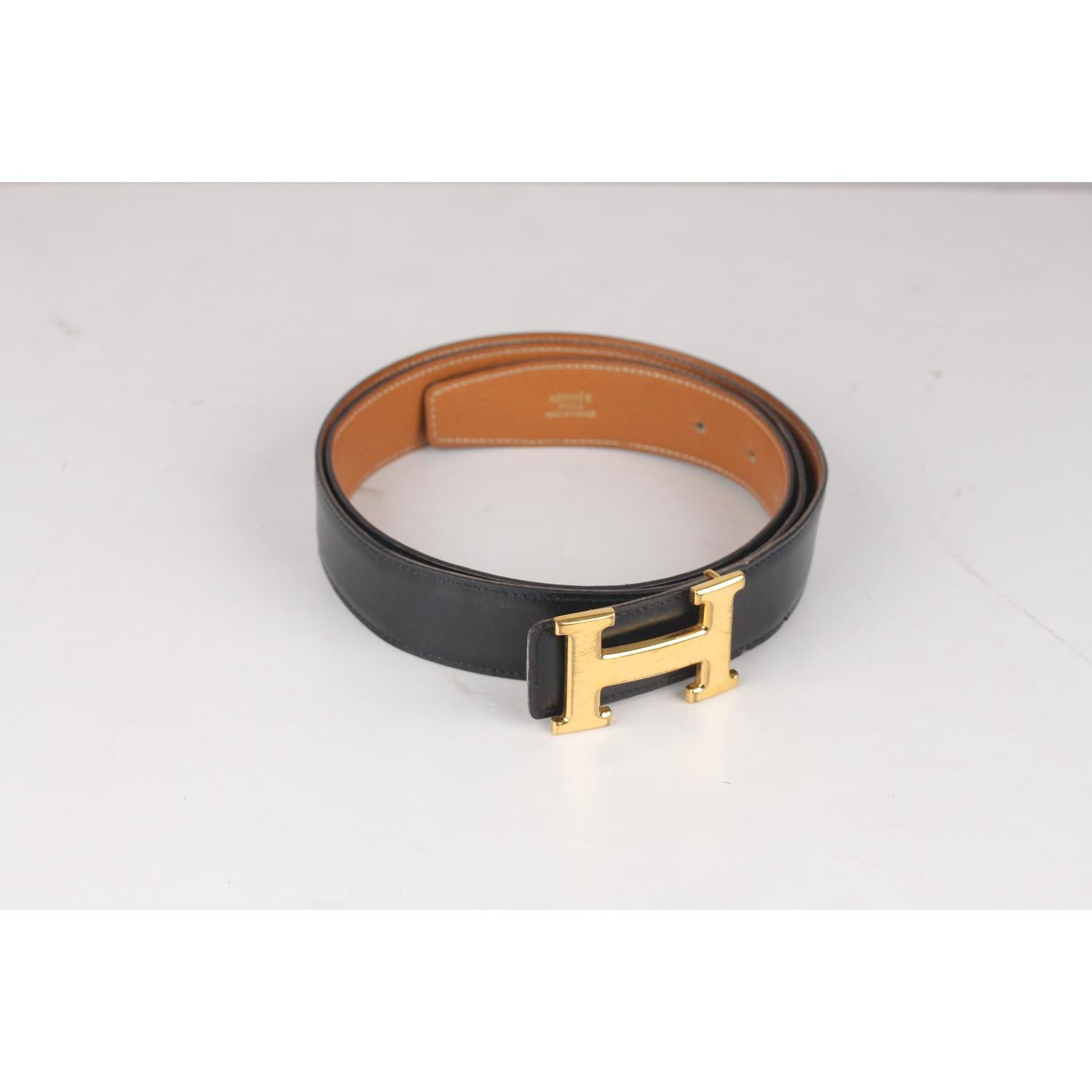 - Hermes Reversible Belt
- Black leather on a side and tan leather on the other side
- Gold metal H Buckle
- Size: 105
- Logo & Tags: 'Hermes Paris - Made in France' engraved on the tan side, 'A' blind tamp encased in a square (Year of production -