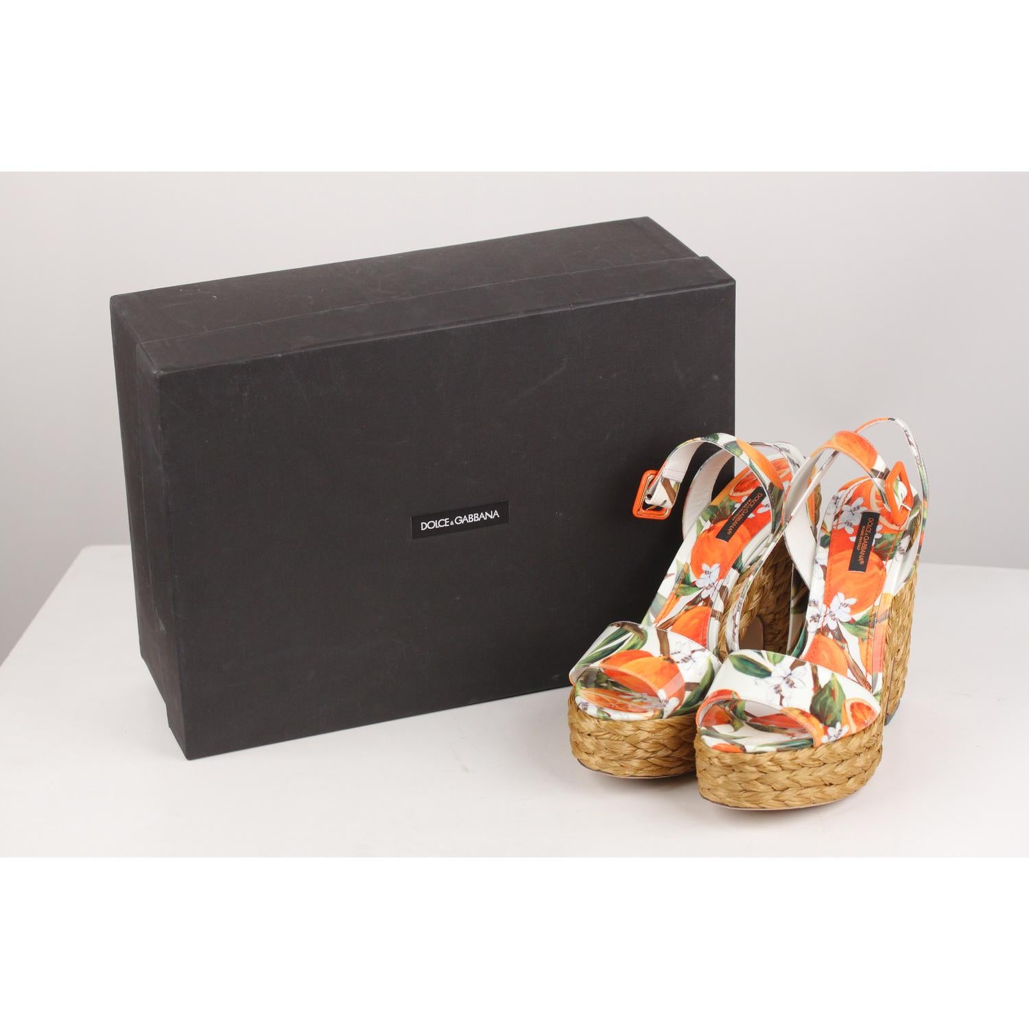 - Dolce & Gabbana Patent leather platform sandals with orange fuits and flowers print
- Woven straw platforms
- Open toe
- Buckle-fastening ankle strap
- Size: 38
- Heels height: 5.5 inches - 14 cm