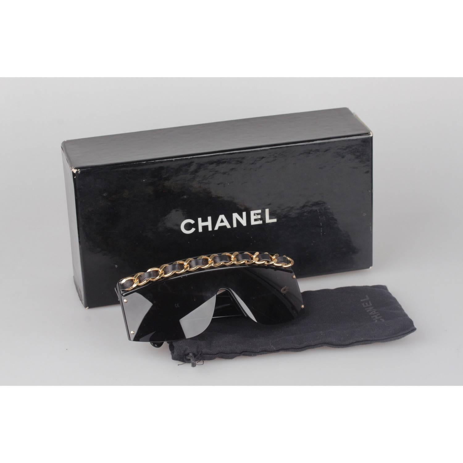 Super Rare 1990s DIVA Chanel Sunglasses
This model was worn by Lady Gaga
Mask shaped, with gold metal & black leather classic CHANEL chain starting from the arms, all the way through the front
Model refs: 01455 - 94305
Made in