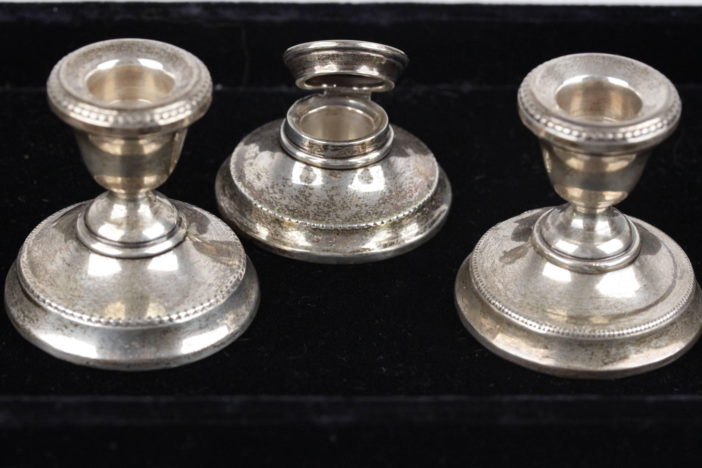  - English antique silver desk set that includes 2 candlestick holder & 1 inkwell
- Circa 1928
- Hallmarks engraved on each piece
- Covered round base
- Base diameter (inkwell): 2 1/4 inches - 6 cm
- Base diameter (candle holders): 2 1/4 inches - 6