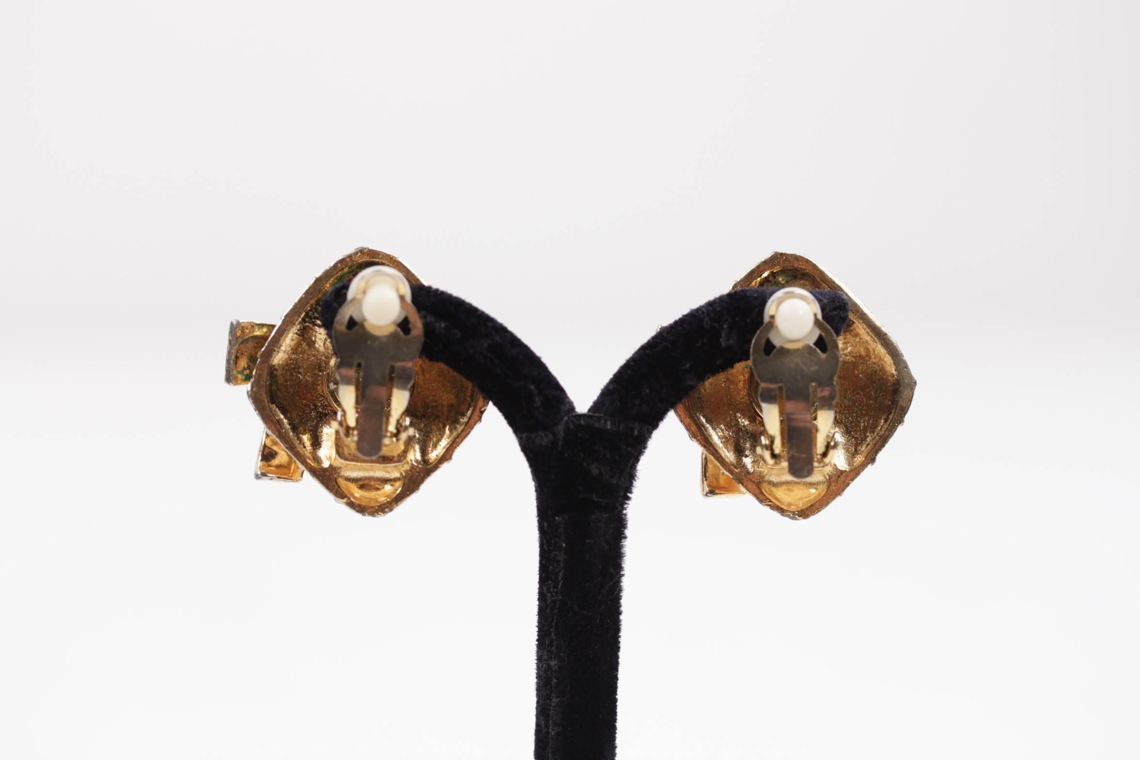 - Clip On Earrings in gold metal by CHANEL

- Period/ Era: 1980s

- Diamond shaped with quilting and bow details

- Clip-on closures

- Signed ' CHANEL CC - made in France' on the reverse of the earrings

- Approx. measurements max width: