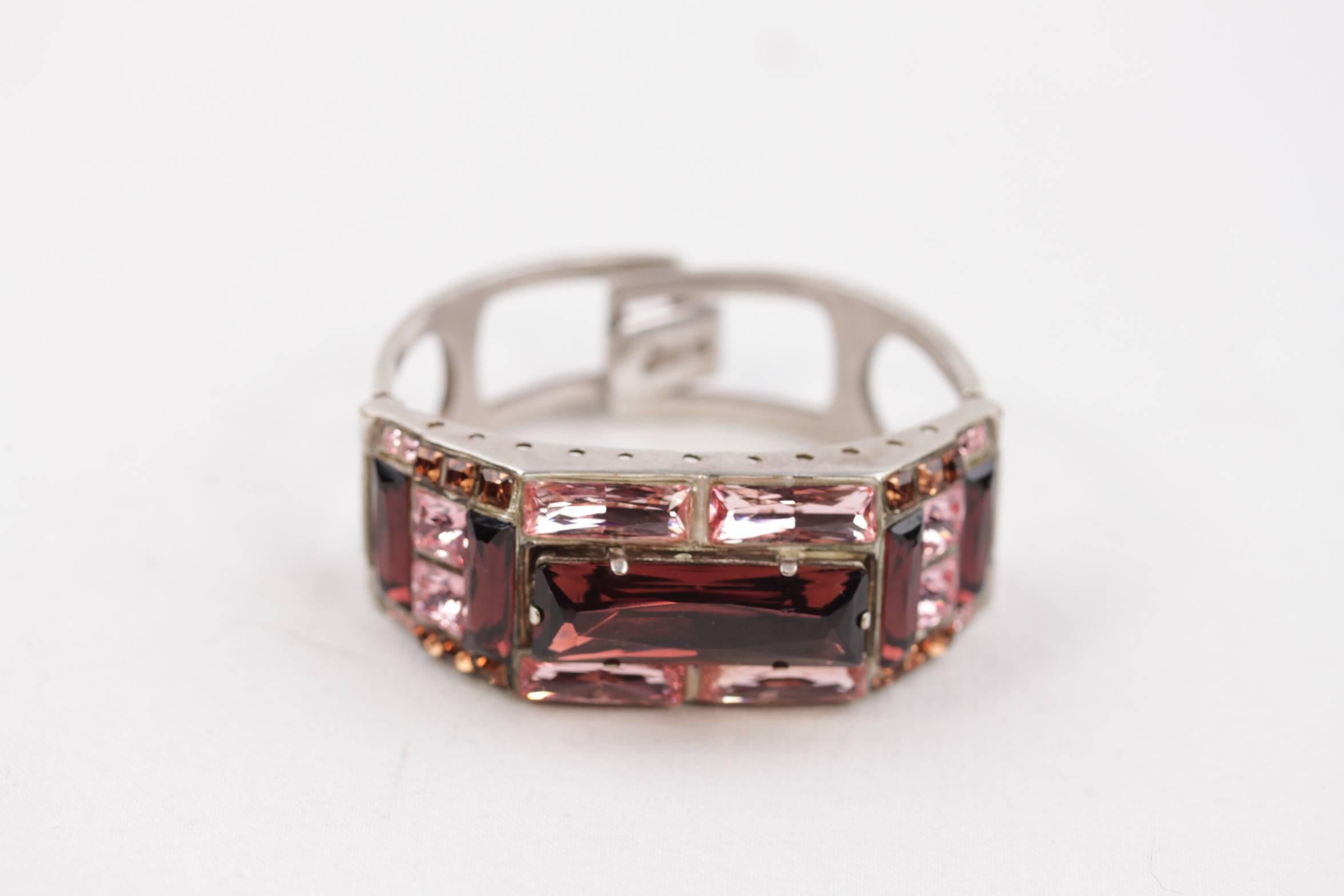 Silver-tone bracelet with pink, burgundy and tan faceted rhinestones by JEAN PAUL GAULTIER

- Clasp closure

- Approx. inner diameter: 2 1/4 inches - 5,7 cm

- Marked 'JEAN PAUL GAULTIER' on the closure

Condition (please read our condition