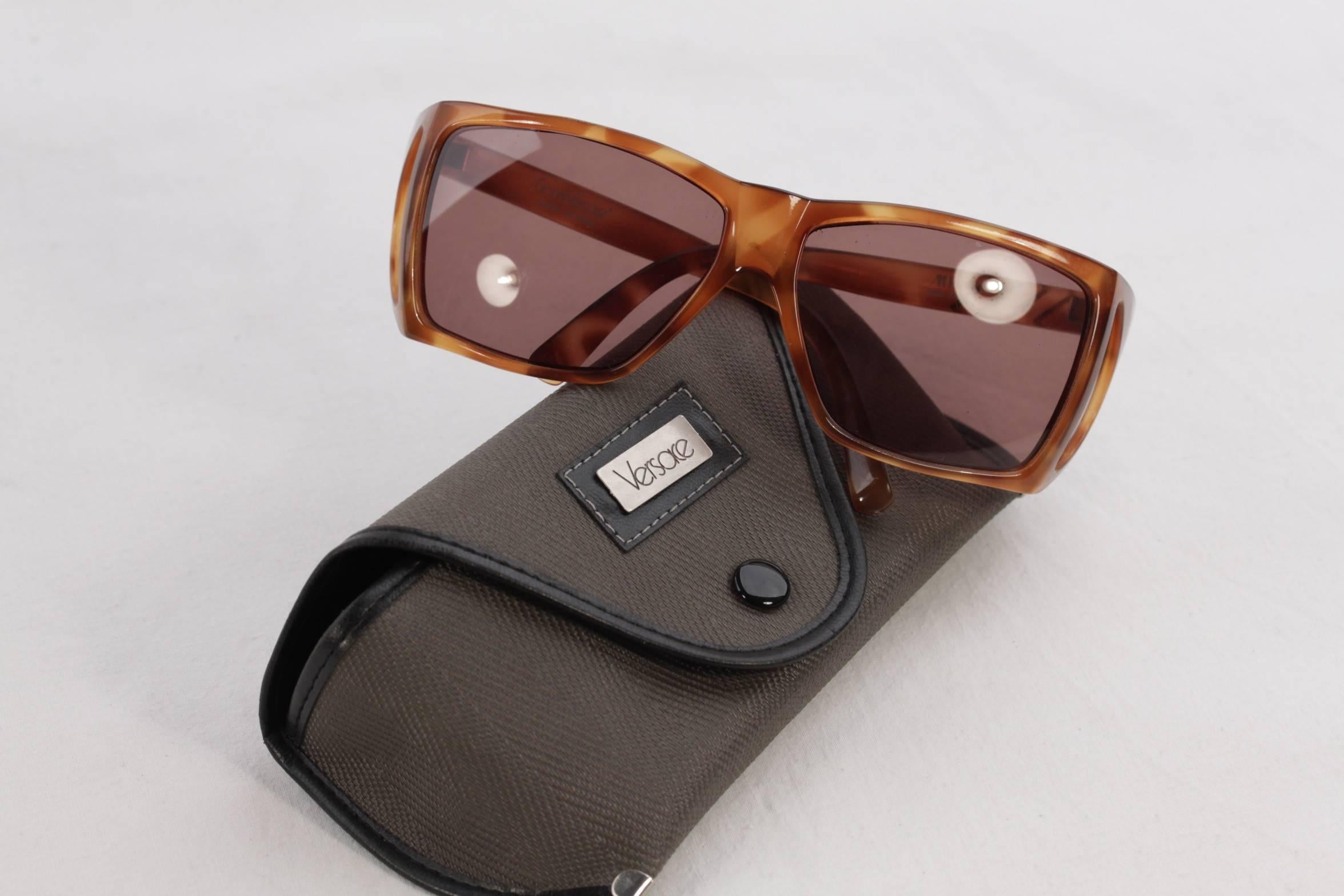 - Tan color acetate frame with silver color diagonal-lines on the left side.

- Two light brown lenses in rectangular shape on the front

- Two smaller light brown color lenses in triangular shape on the side-edges

- Made in Italy in the late