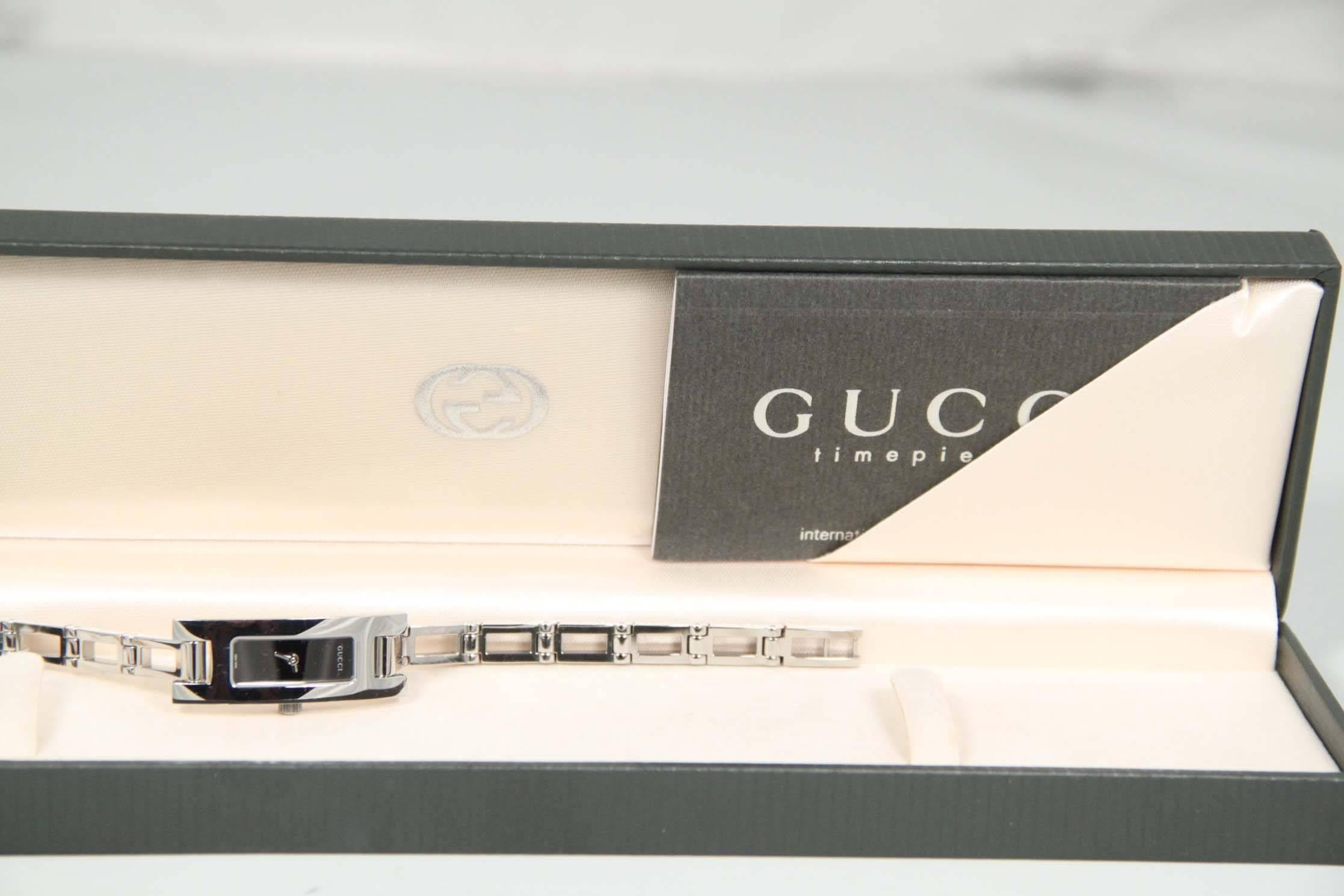 BRAND: GUCCI

MADE IN: Switzerland

LOGOS & TAGS: GUCCI written on the movement, G embossed on the crown

REF.ID: GUCCI Timepieces 3900L - 0109490

FURTHER COMMENTS: Women's stainless steel watch, model 3905L, by GUCCI. Black color dial with